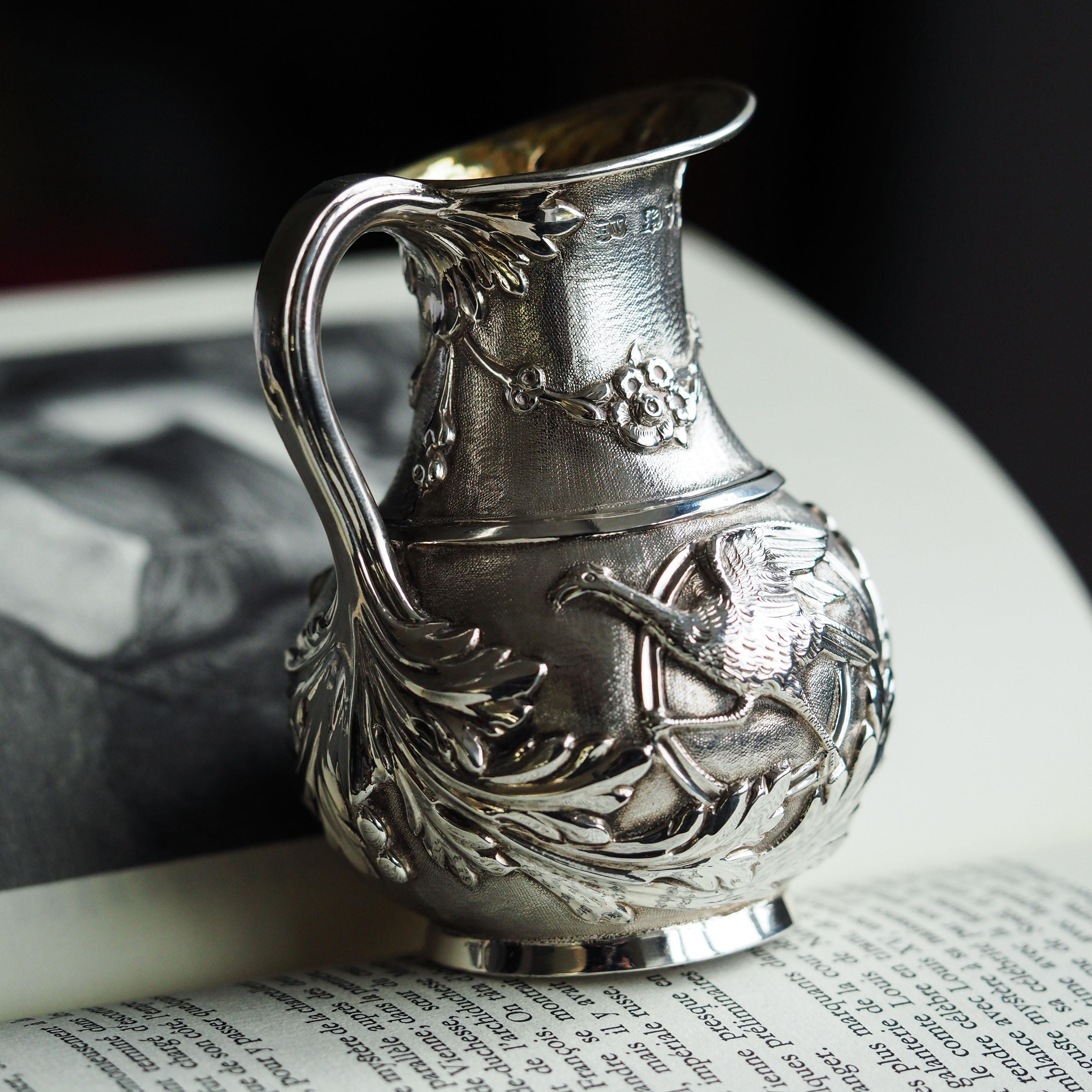 We are delighted to offer this magnificently decorated antique solid silver Victorian milk pitcher made in London, 1863 with marks for Henry Wilkinson.

This pitcher features a most wonderful three-dimensional design with high embossing. The entire