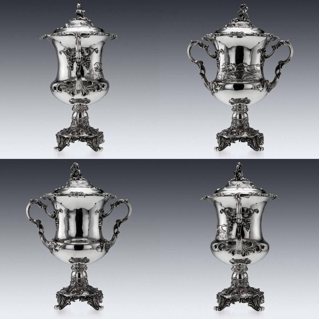 Antique 19th century magnificent Victorian solid silver monumental trophy cup and cover, Campana form, 55.5 cm tall, chased and embossed with scrolls and foliage, applied cast scroll handles, one side applied with racing horses.

The cover also