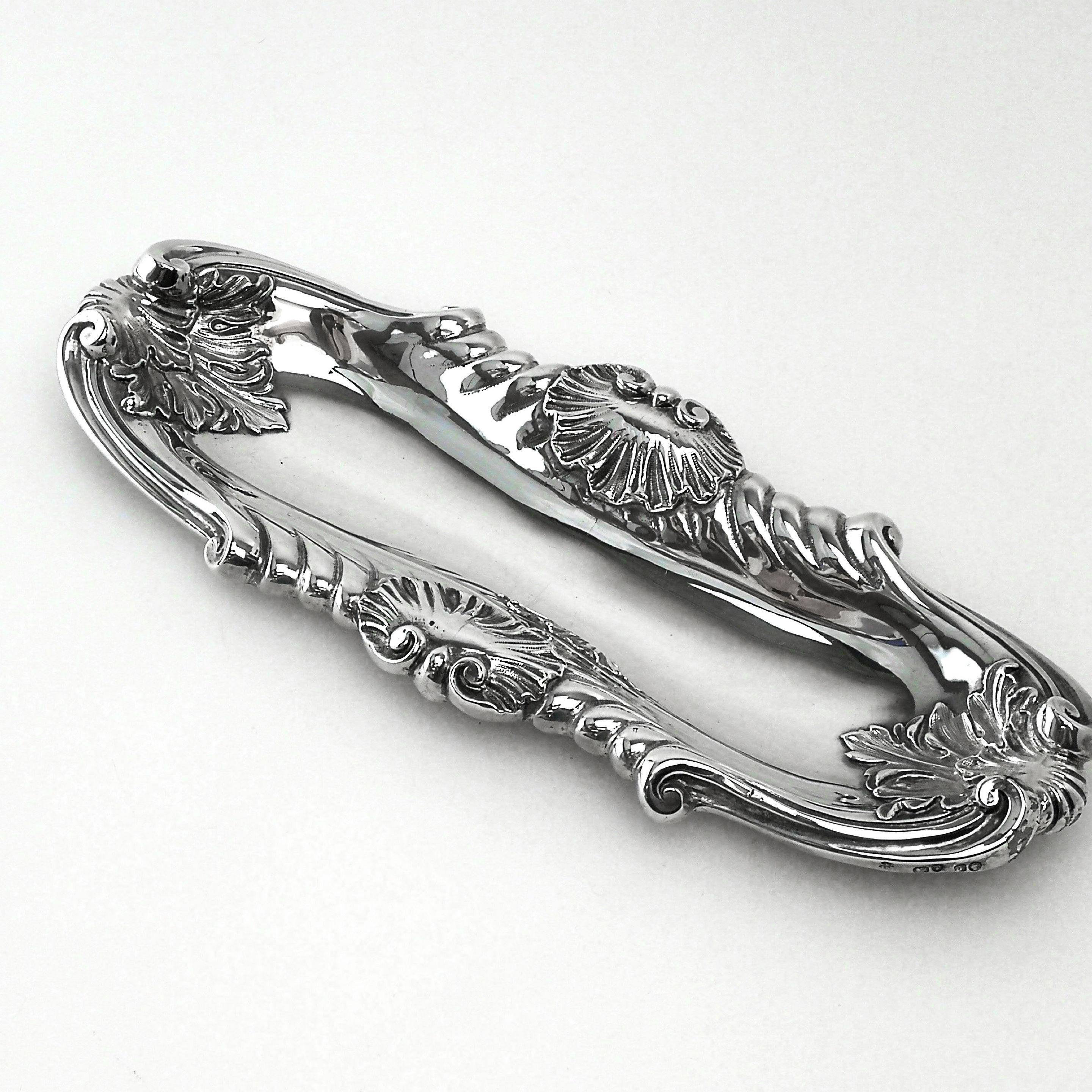 An attractive antique Victorian solid silver pen tray / pin or trinket tray with a bold deep relief chased shell and scroll border. This tray is ideal for pens on a desk or trinkets on a vanity table.
 
 Made in London in 1854 by John S. Hunt.
