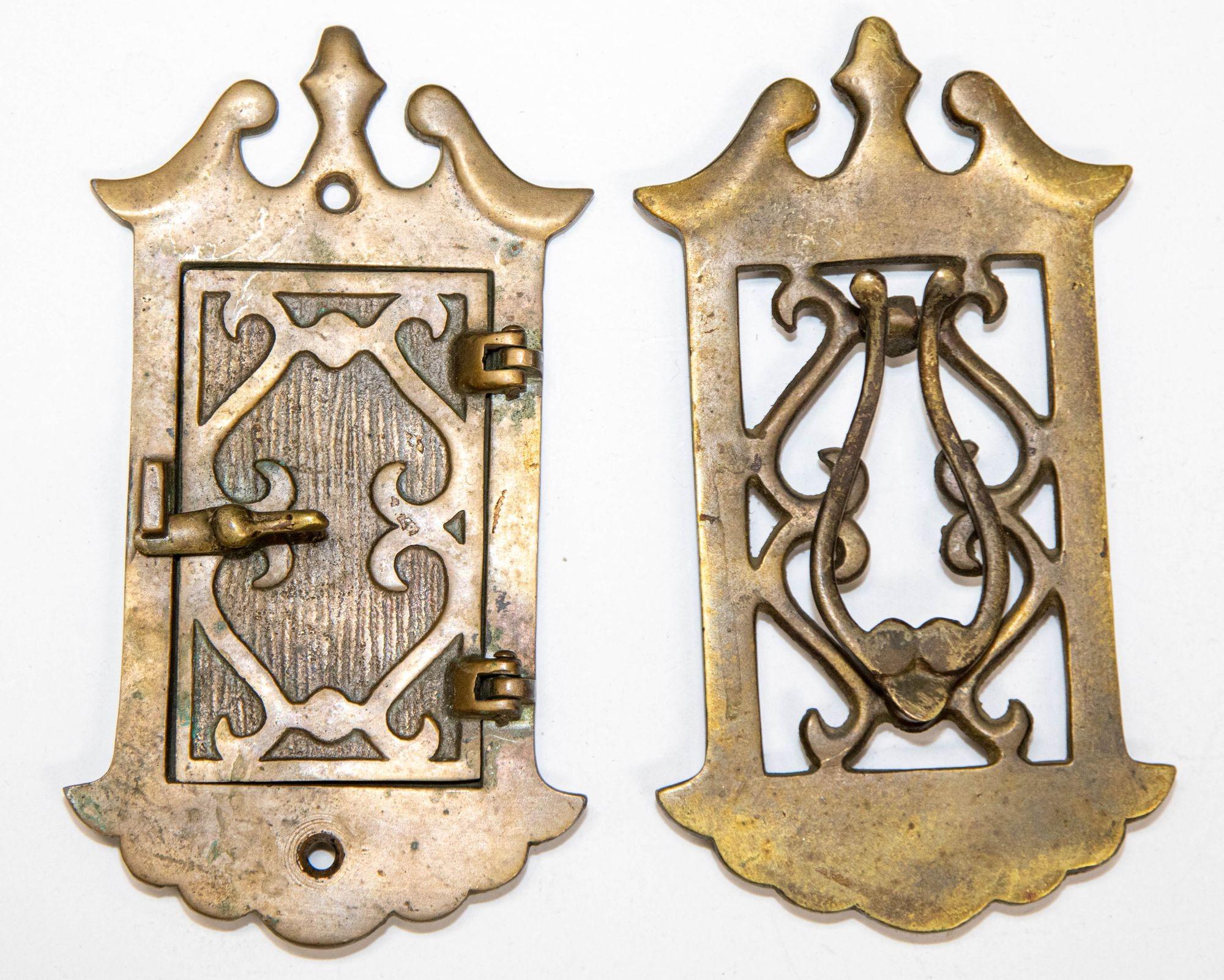Antique Speakeasy Door Knocker Viewer and Peephole Grill in Two Panels.
Art Deco, Victorian, Chippendale style Speakeasy or Door Viewer. 
A two panel speakeasy door knocker and grill with a large inner peephole of rectangular shape that opens on