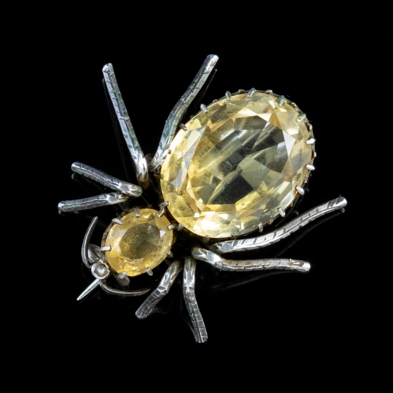 A fascinating Antique Victorian Brooch in the shape of a Spider, made from Silver and adorned with two large Citrine Stones, one measuring 15ct and the other 1.50ct.

Insect jewellery is highly collectable and was once considered a symbol of good