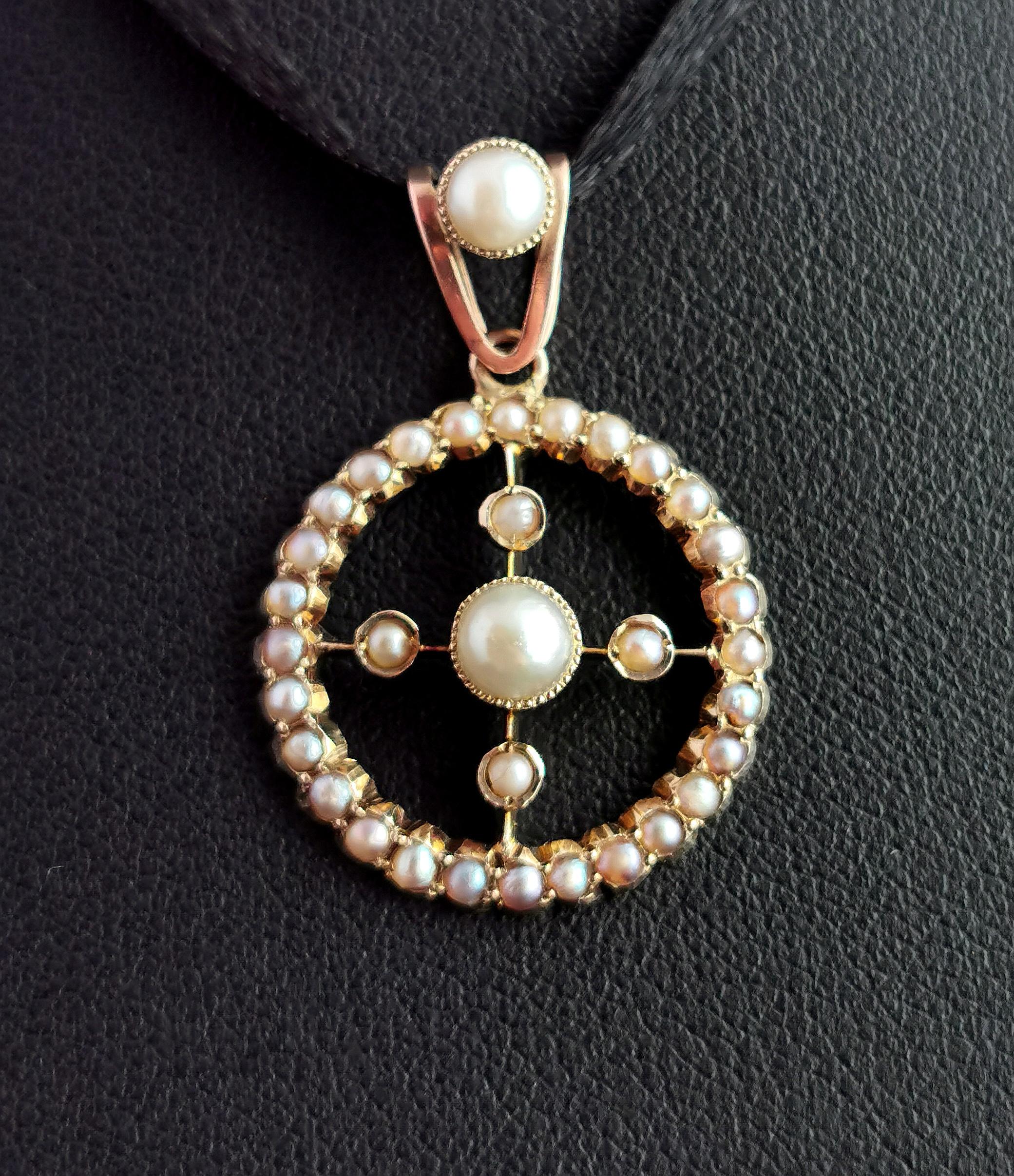 A beautiful and unusual Victorian split pearl and seed pearl pendant.

It is a circular shaped pendant with a gold cross running through the centre set with a large split pearl with four on each of the bars.

The outer circle is set with a halo of