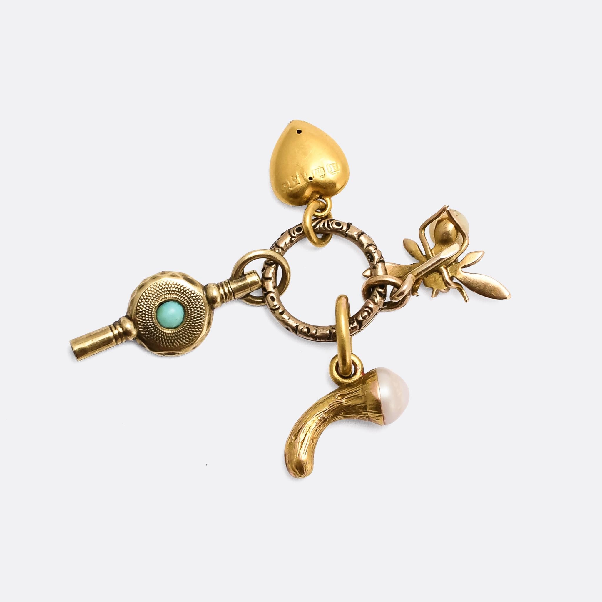 A collection of miniature charms with split ring, all dating from the 19th century. They include a gold heart, pearl, diamond and sapphire set bug, turquoise set watch key, and a cornucopia with pearl spilling out the end. The split ring features