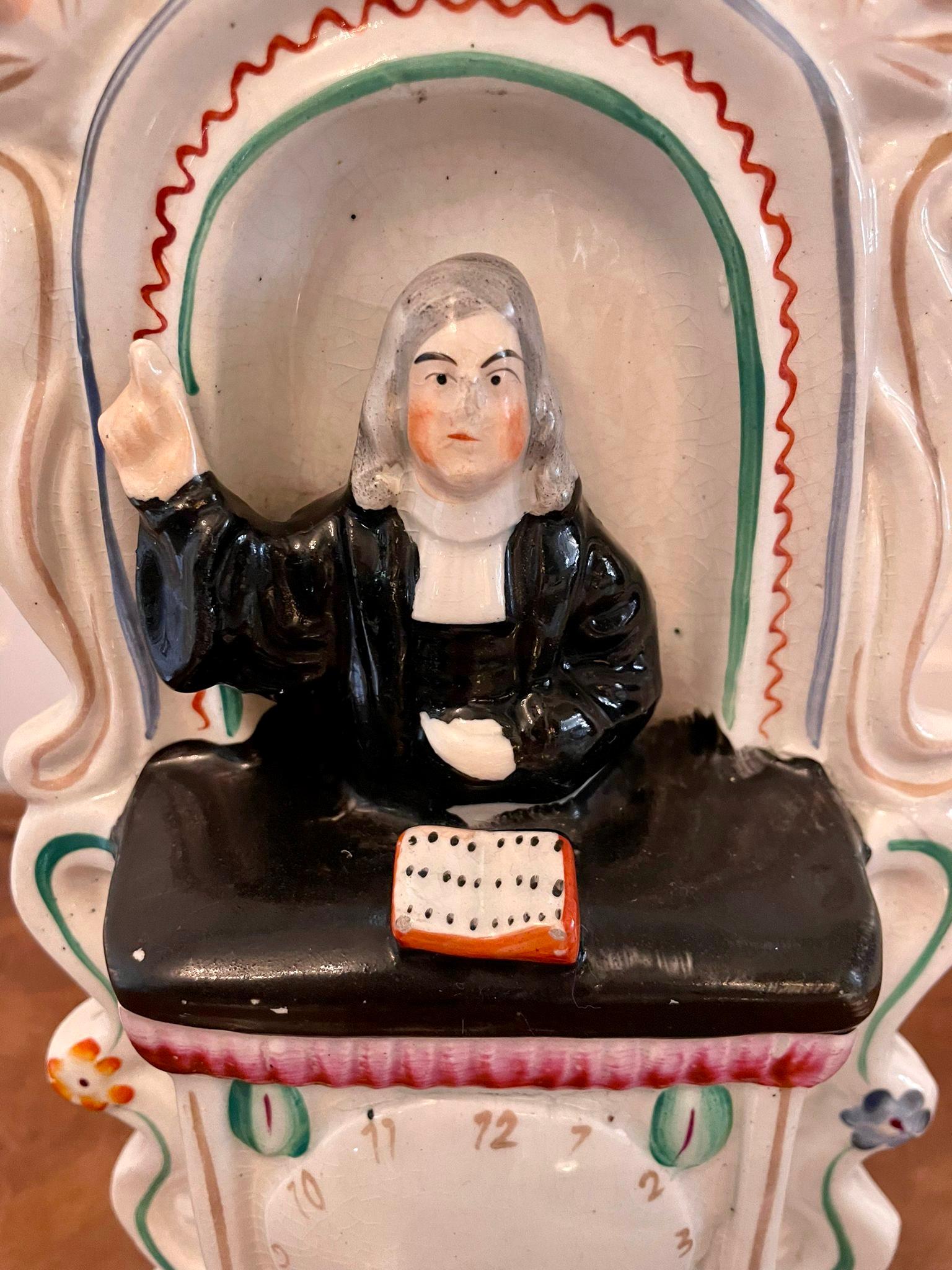 Antique Victorian Staffordshire figure of John Wesley preaching from the pulpit above a clock in wonderful colours.

Measures: H 20.5cm 
W 15cm 
D 7.5cm 
Date 1860.
 