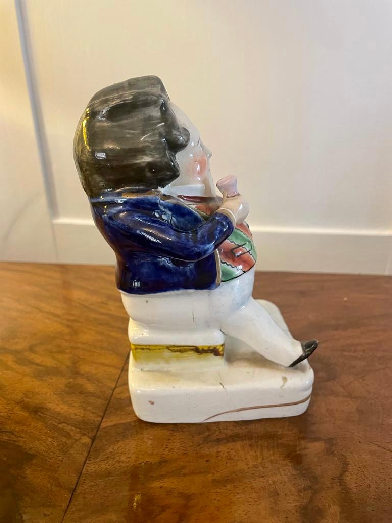 Antique Victorian Staffordshire flatback figure of a seated man in period costume holding a drink

Measures: H 14.5cm x W 7cm x D 8cm
1880.
  