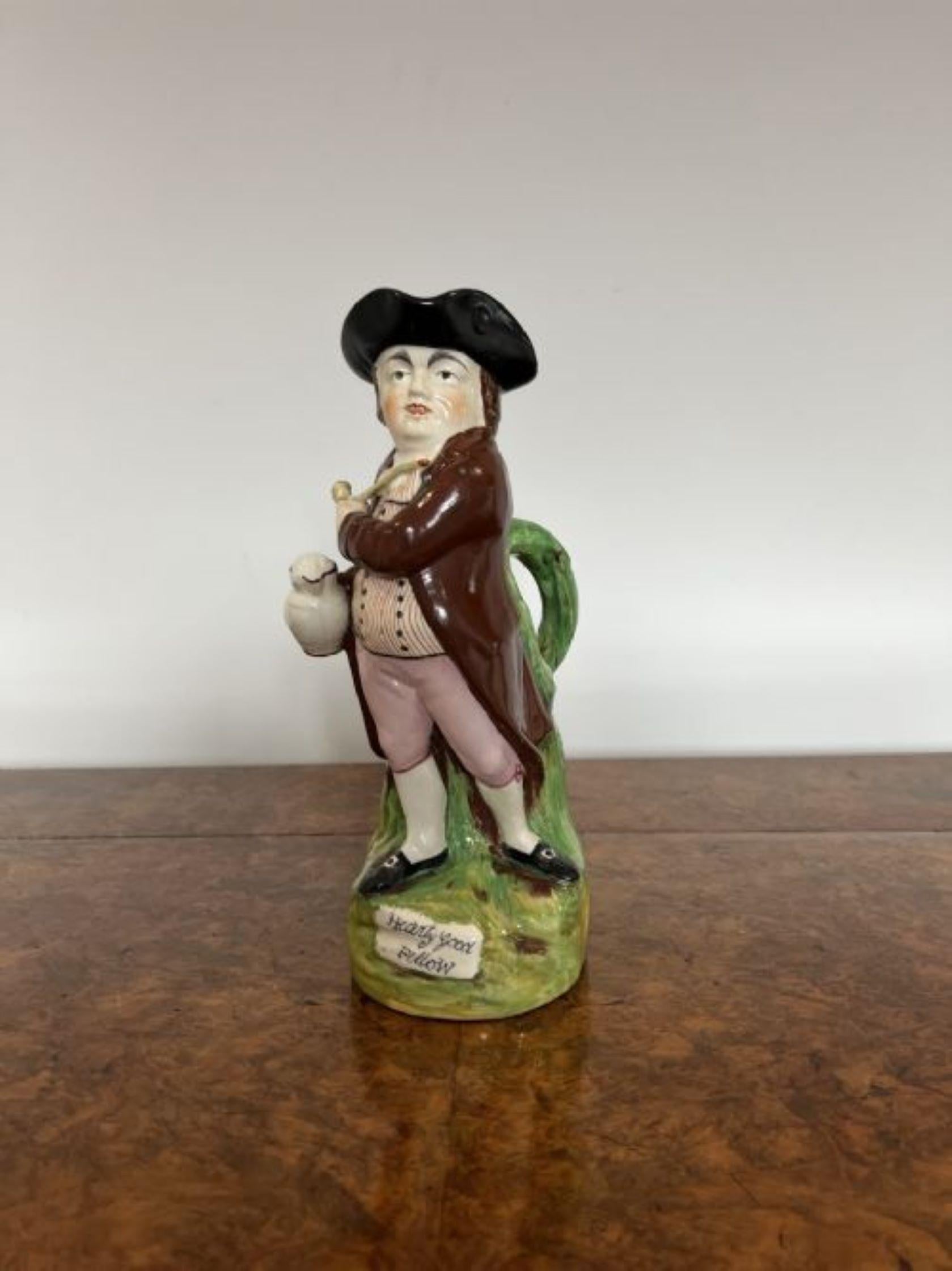 Antique Victorian Staffordshire Toby Jug having a quality Victorian Staffordshire toby jug of a man in wonderful period clothing in red, pink, green, white and black vibrant colours holding a jug of ale in one hand and a pipe in the other, with a