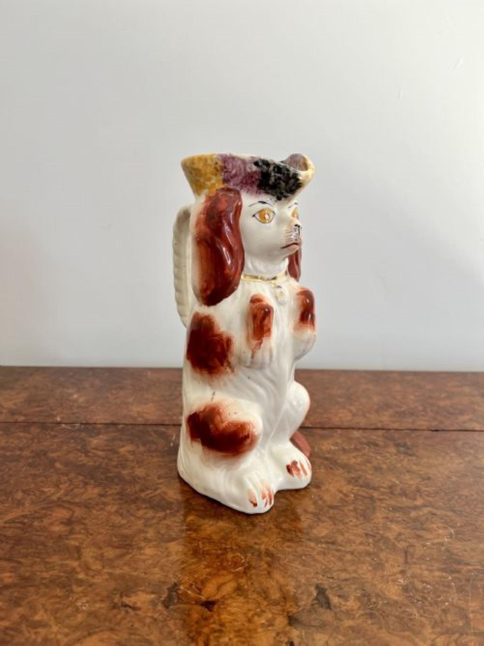 Antique Victorian Staffordshire Toby Jug of a spaniel, Having a hand painted Red and White coloured coat, with a gold collar and padlock, standing upright.
