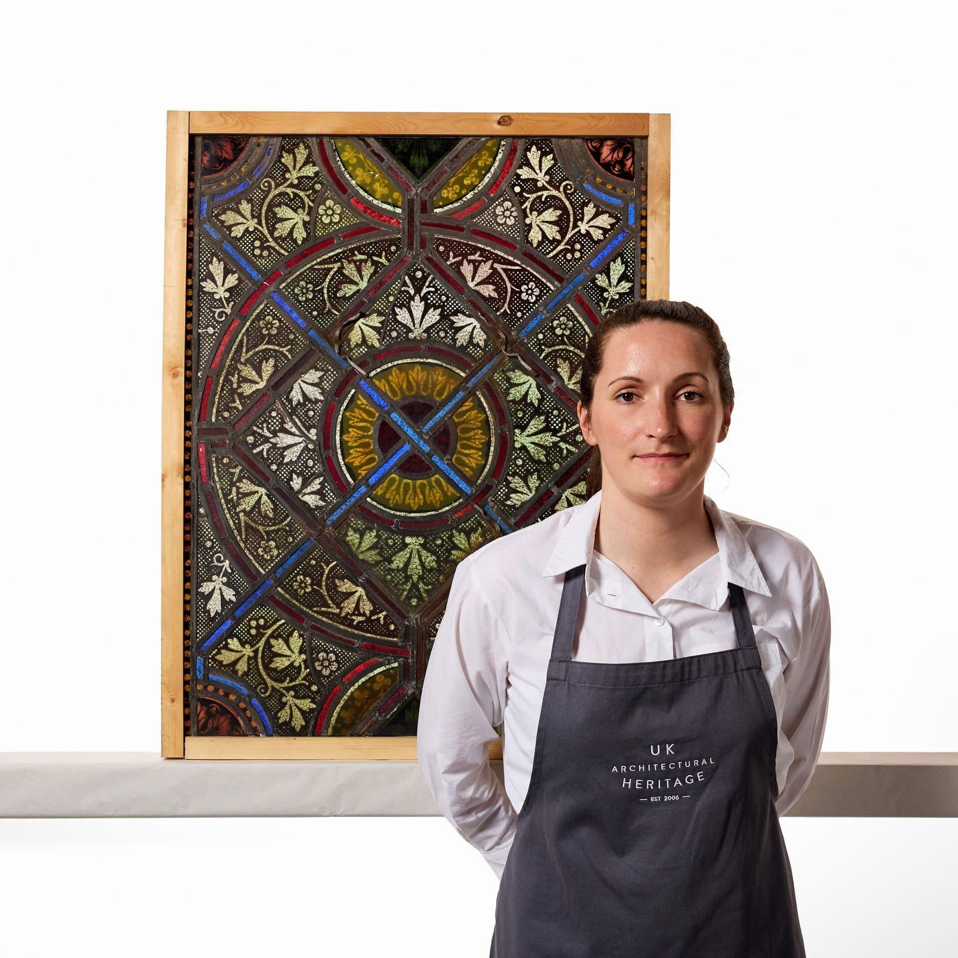 A colourful and beautifully detailed antique Victorian stained glass window, one of four similar in design we are selling. This stunning window pairs intricate foliage patterns with red, blue, orange and yellow panes of stained glass placed in lines