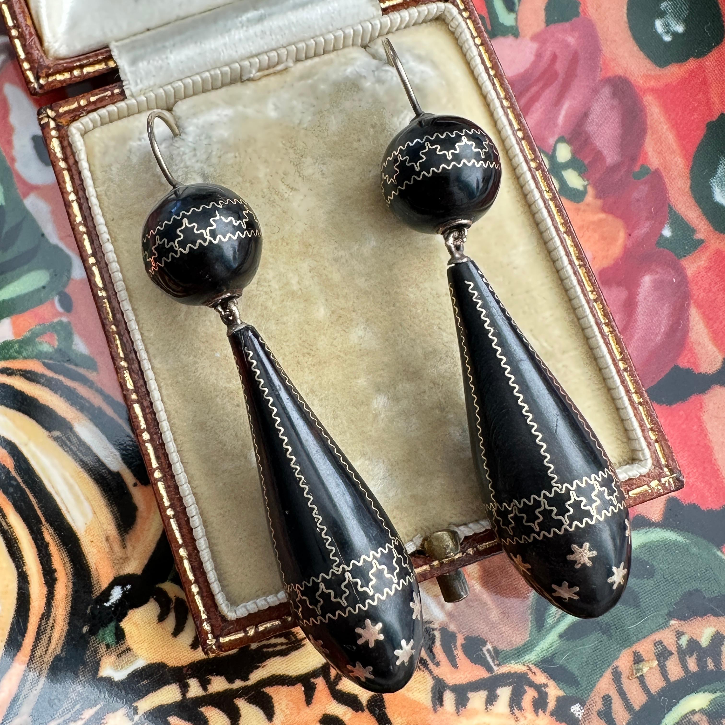 Details: 
Fabulous Victorian black pique work detailed inlay torpedo drop earrings with 14K yellow gold details. These earrings are magnificent, and very dramatic. They have gold inlay with sweet Etruscan and star pattern. There are tiny stars at