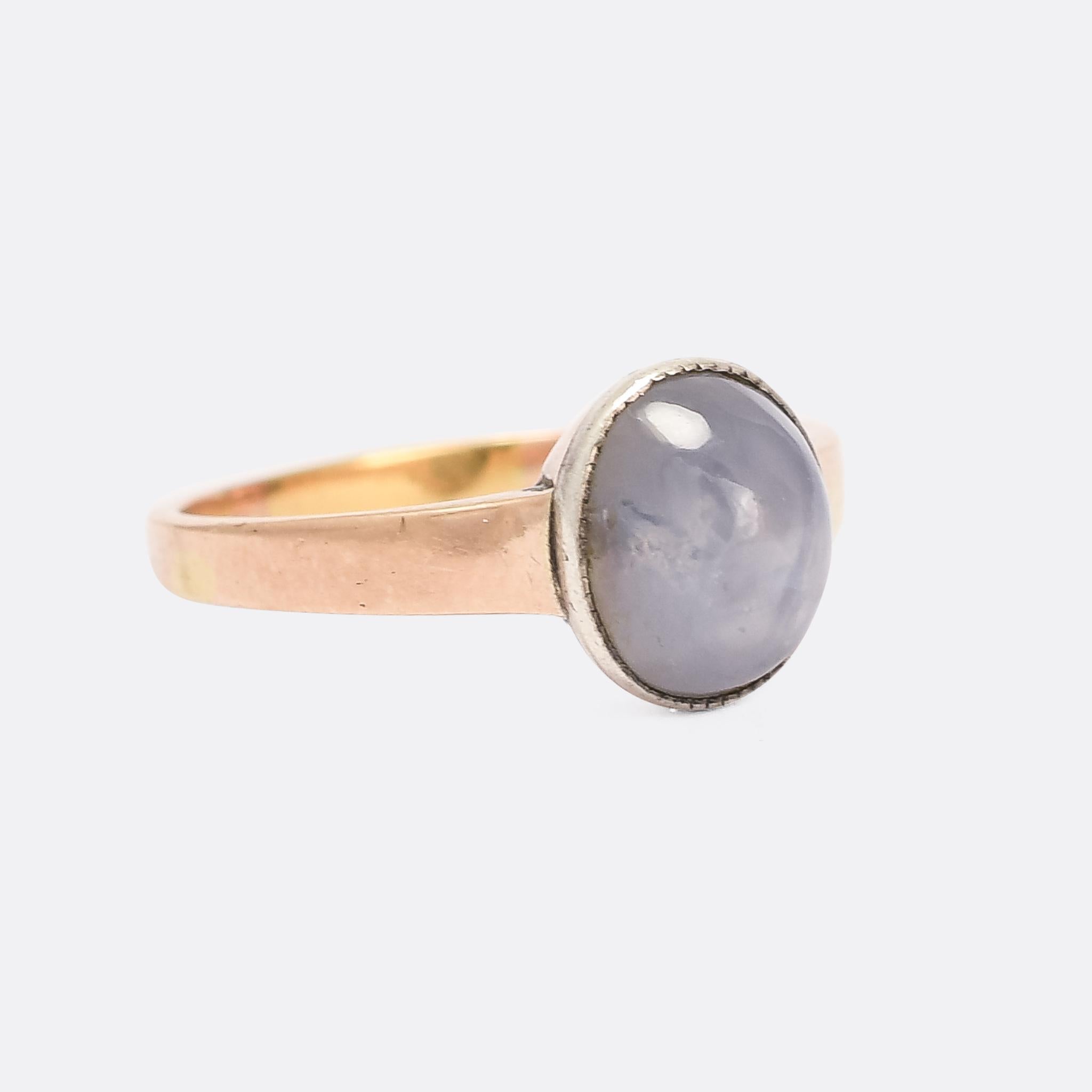 A gorgeous antique solitaire ring set with a blue star sapphire cabochon. It's French, with swan and clover hallmarks for silver and 9k gold respectively, and was made around the turn of the 20th Century. The stone displays six pointed asterism,