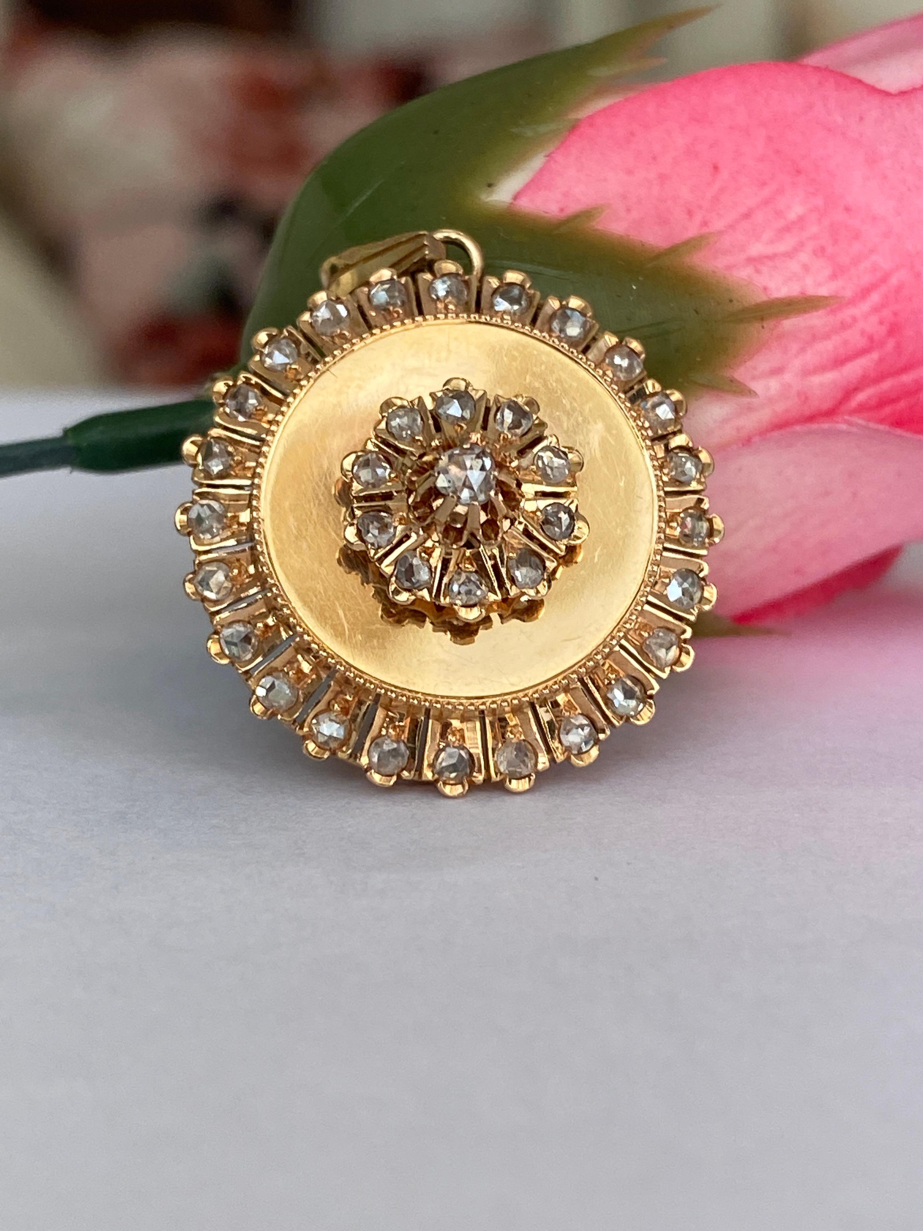 Delicate, romantic, and rich with history, this Victorian-era pendant features a charming flower-set design, centered around a shimmering rose cut diamond. Crafted in warm 14 carat yellow gold, the piece beautifully embodies the sentimental artistry