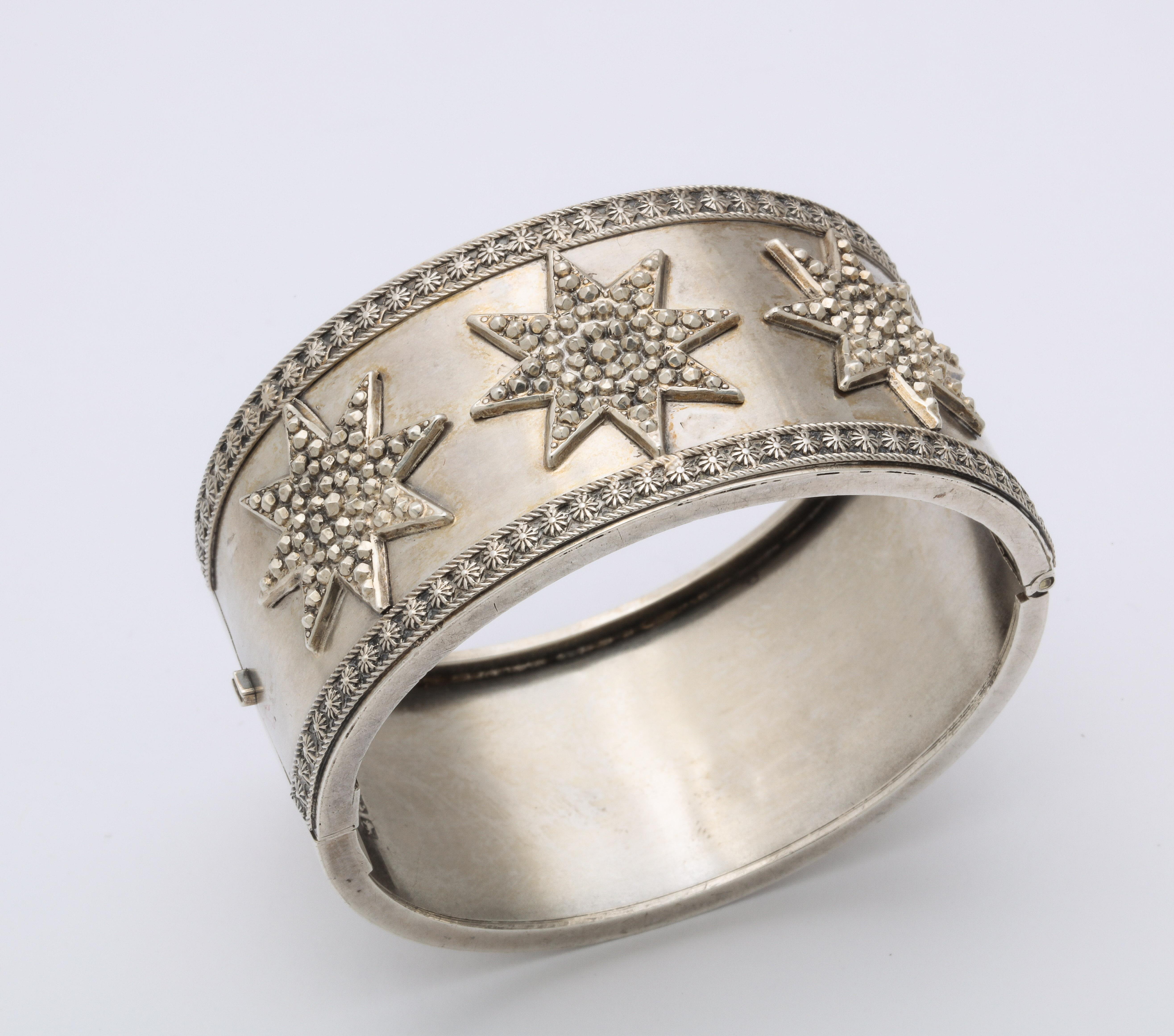 A dazzling, Victorian sterling bracelet, full of hand engraving, struck with three faceted raised stars, is one of the more unusual bracelets made during the silver revolution in Great Britain from c.1860-1880. I have not seen another. Note the