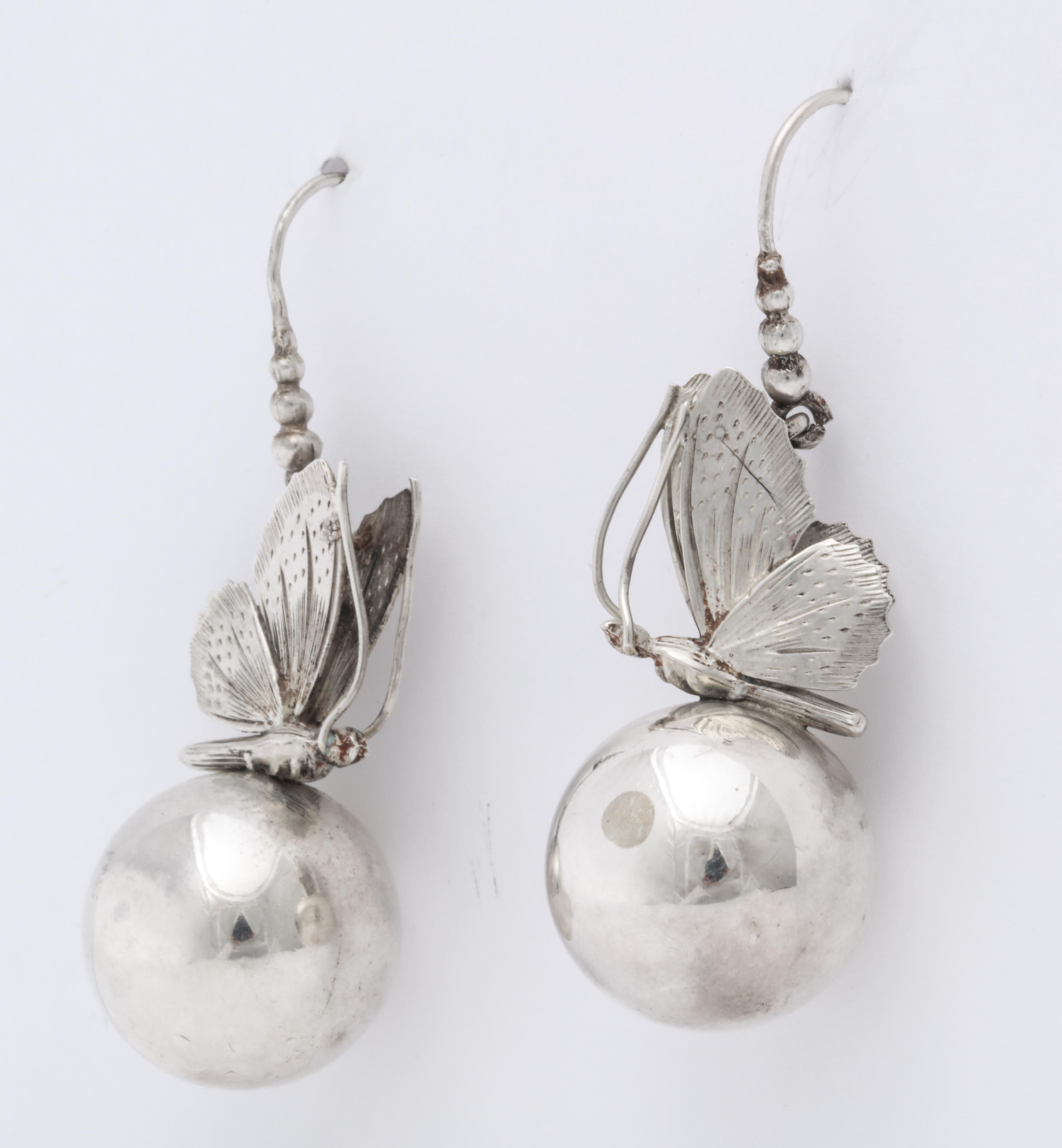 Light as air, unlike any manufactured silver earrings, the detail on this Victorian  butterfly is a work of art as it alights on the ball below it. Notice how realistic the insect appears with its antennae, body,  head and engraved wings. Made in