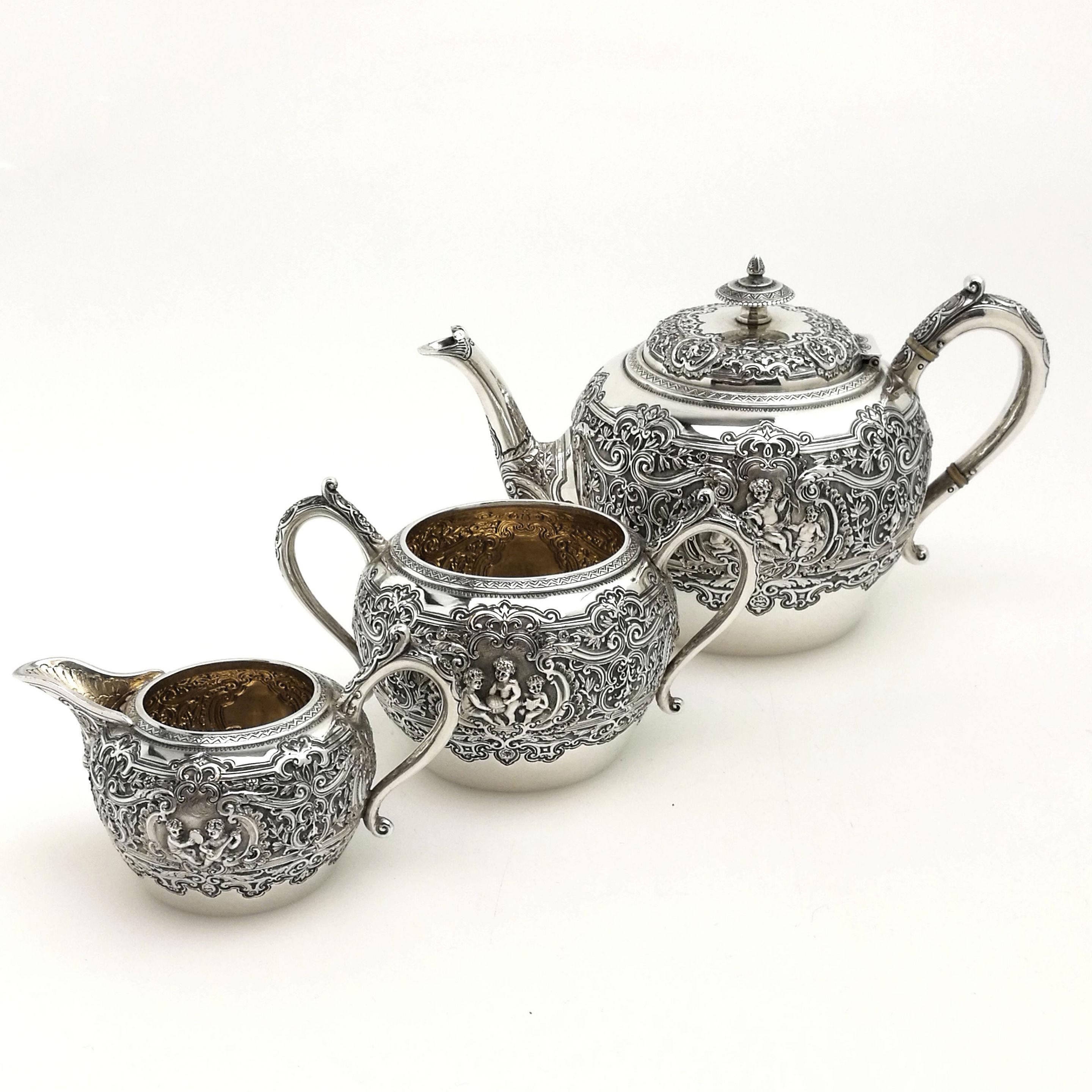 A lovely Antique Victorian solid silver three-piece tea set comprising of a teapot, sugar bowl and cream jug. Each piece in this set is decorated with ornate detailed chasing including floral, foliate and scroll patterns. Each piece has a pair of