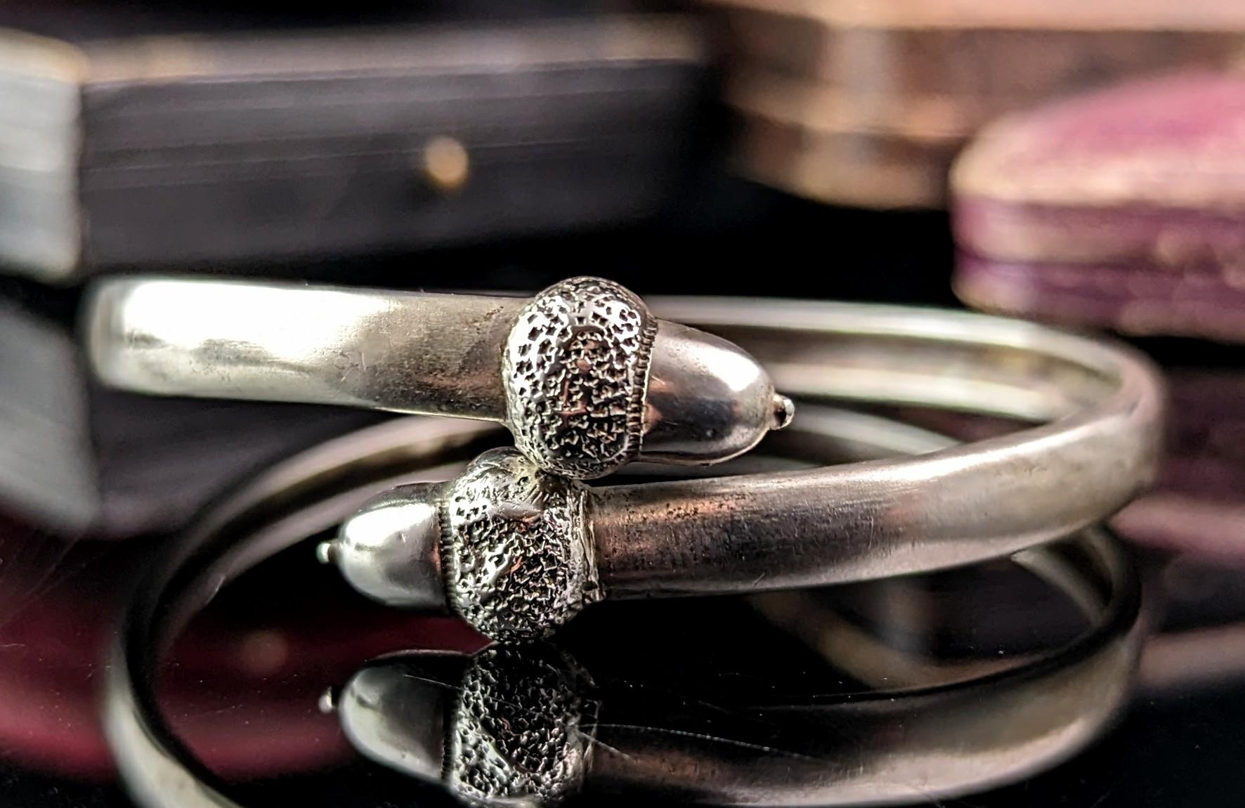 You can't help but fall in love with this charming antique, Victorian era, sterling silver bypass bangle.

Designed as a simple bypass bangle, similar to a torque bangle, it has wonderful acorn finials.

Acorns were a very popular motif in Victorian