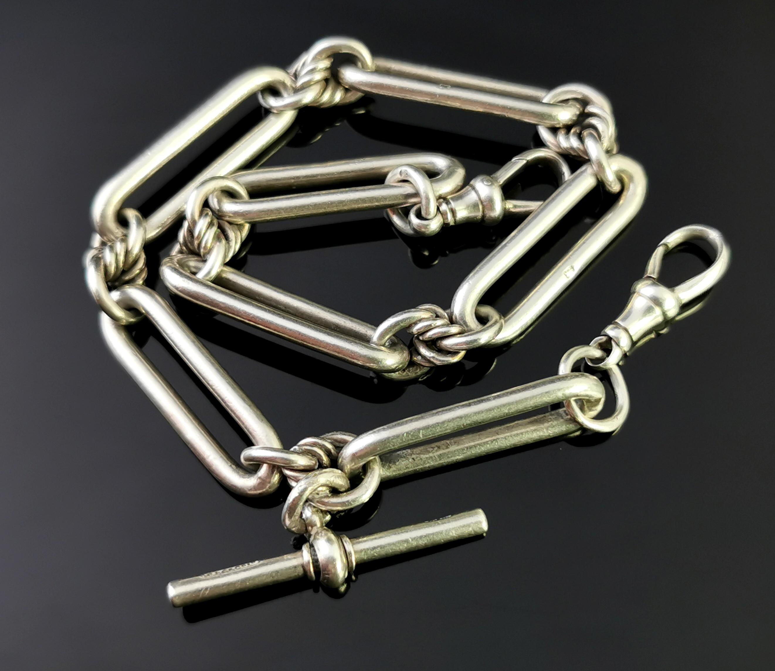 An attractive antique, Victorian era sterling silver fancy link Albert chain or watch chain.

Nice chunky trombone links with a dog clip fastener to each along with a t bar.

It has two chunky silver dog clip fasteners both marked for sterling