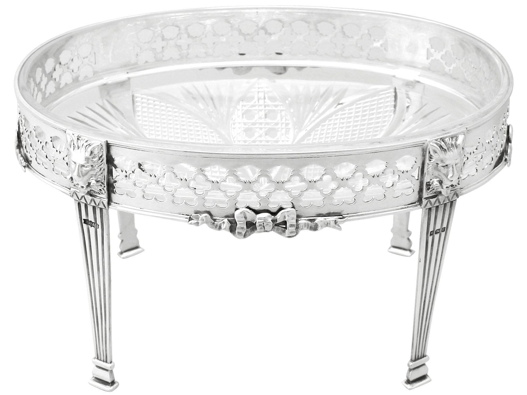 An exceptional, fine and impressive antique Victorian English sterling silver and cut-glass centerpiece; an addition to our ornamental silverware collection

This exceptional antique sterling silver centerpiece has a an oval form onto four pillar