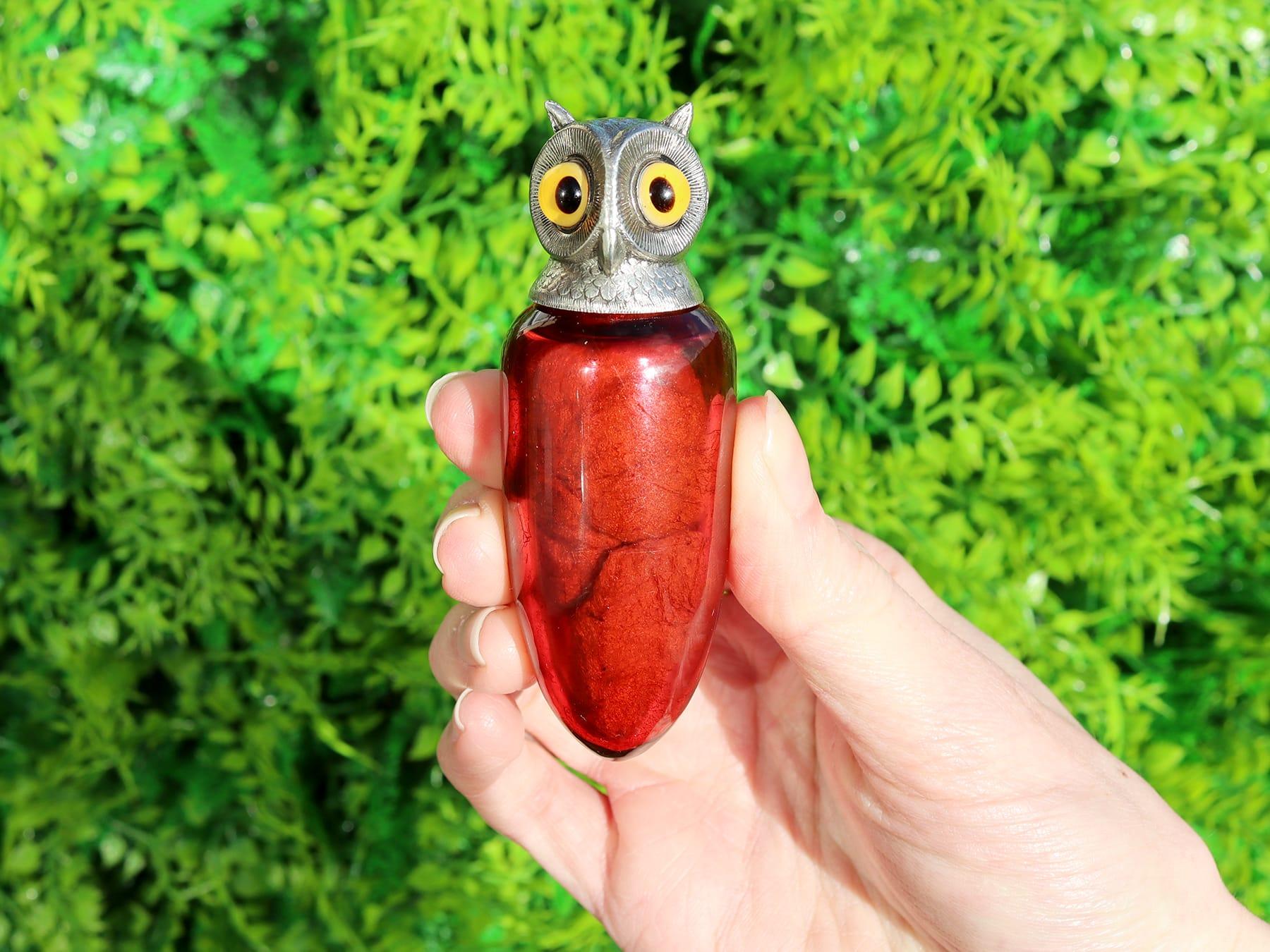 An exceptional, fine and impressive antique Victorian English sterling silver and cranberry glass owl scent bottle; an addition to our diverse collectable silverware collection.

This exceptional antique Victorian sterling silver scent bottle has a
