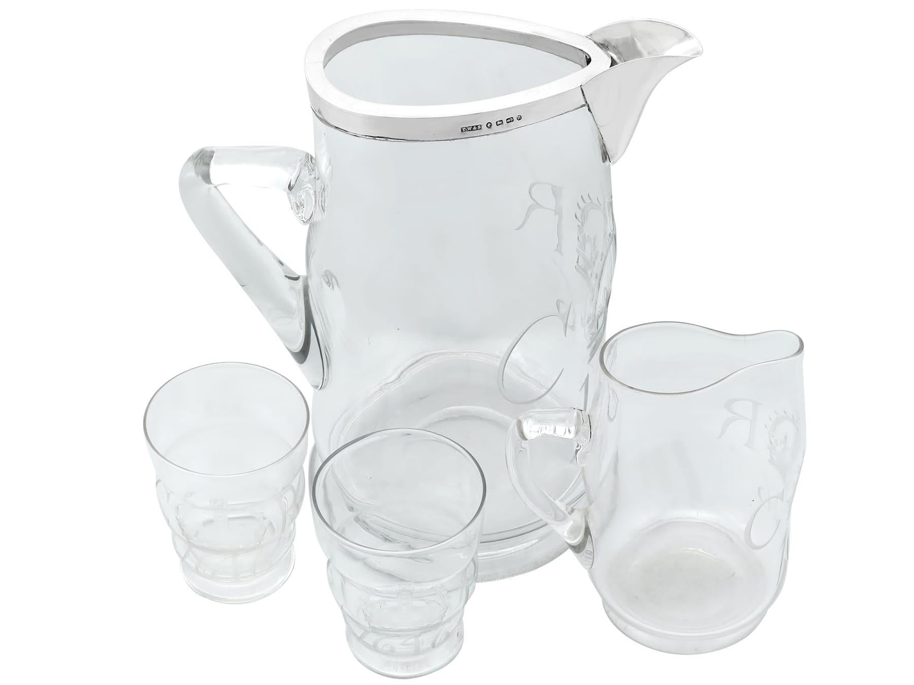 A very fine and impressive antique Victorian English sterling silver and glass water jug with a matching pair of glass tumblers; an addition to our diverse glassware collection.

This fine and impressive antique Victorian sterling silver and glass