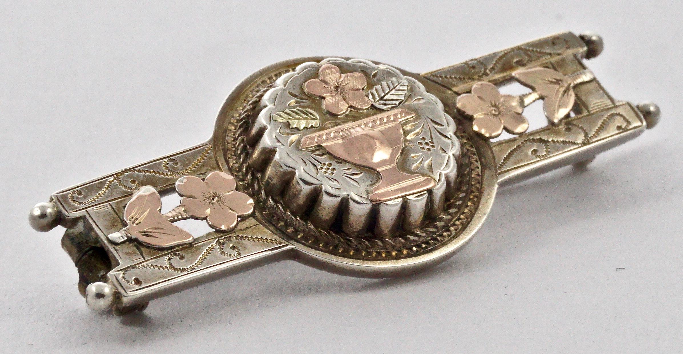 Wonderful Victorian hand chased ornate sterling silver bar brooch, with a lovely vase, flowers and leaves gilded in rose gold and yellow gold. Measuring length 4cm / 1.6 inches by width 1.6cm / .6 inch. The 
