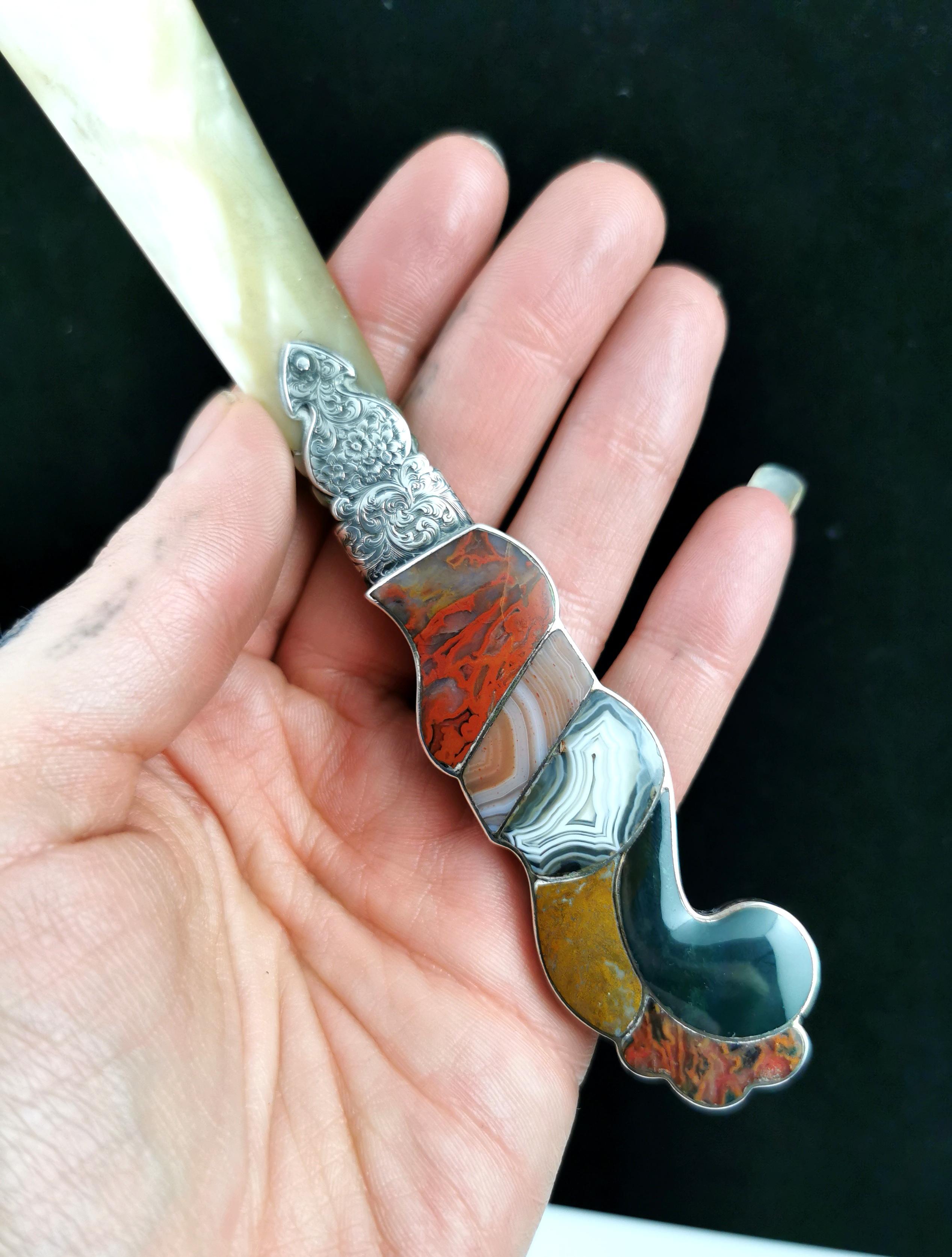 A beautiful antique, Victorian era Scottish agate and Silver letter opener. 

This is such an elegant piece, it has a mother of pearl blade for carefully opening all your important mail. 

The handle is made up from delightful high polished