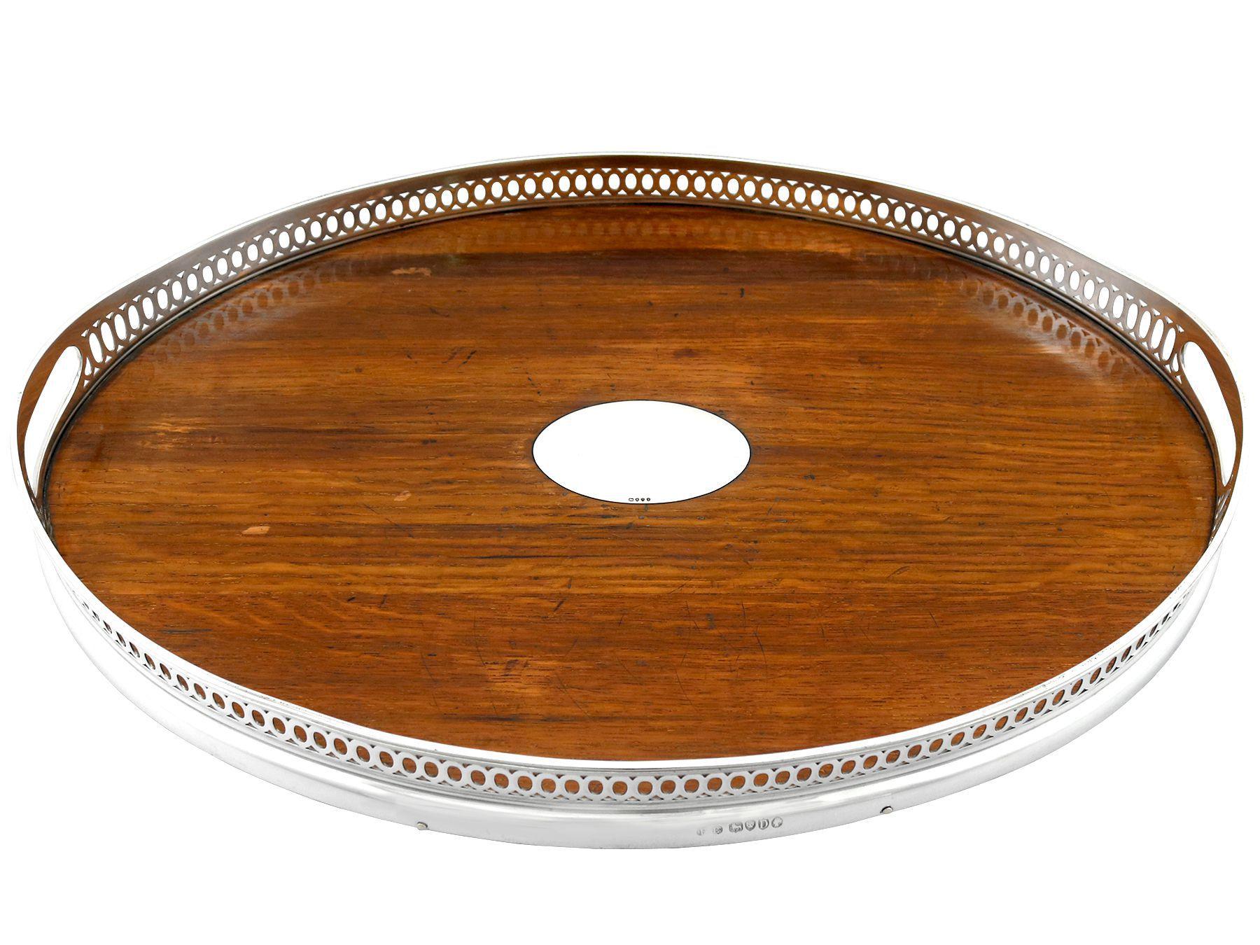 An exceptional, fine and impressive, antique Victorian English sterling silver and wood galleried tray; an addition to our Victorian teaware collection.

This exceptional antique Victorian sterling silver gallery tray has an oval form.

The deep
