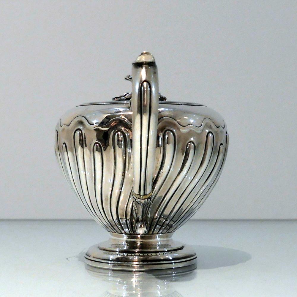 A stunningly beautiful early Victorian silver bachelor teapot decorated with elegant spiral fluting to the body and having a splendid ornate cast spout. The lid has a flush hinge and is crowned with an elegant floral finial.

Weight: 14.2 troy