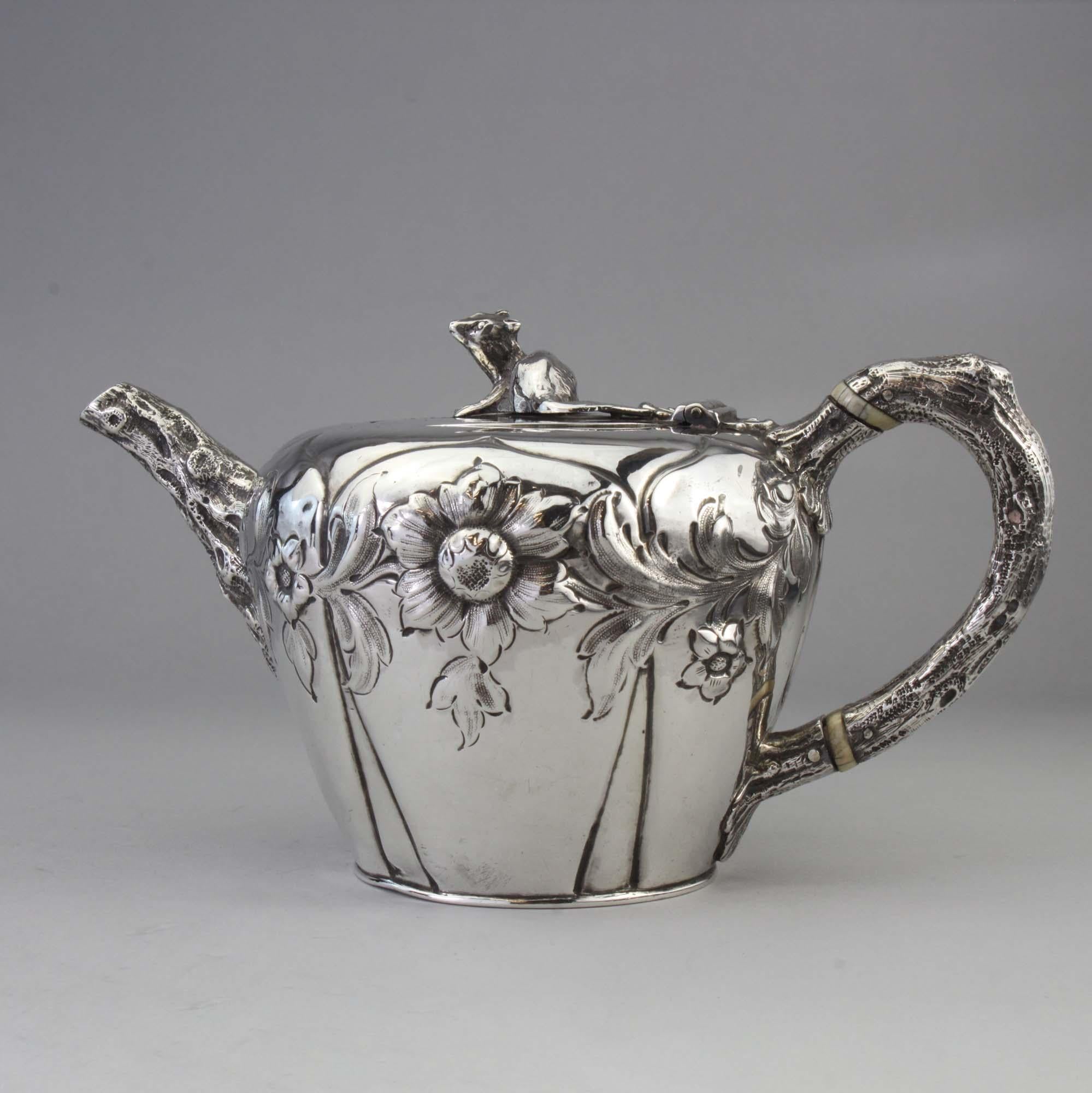 Antique Victorian Sterling silver bachelor's tea pot 

Tea pot is tapering circular form, has embossed foliate decoration.
The spout and scroll handle with textured bark effect.
The hinged cover with a squirrel finial.
Length handle to spout