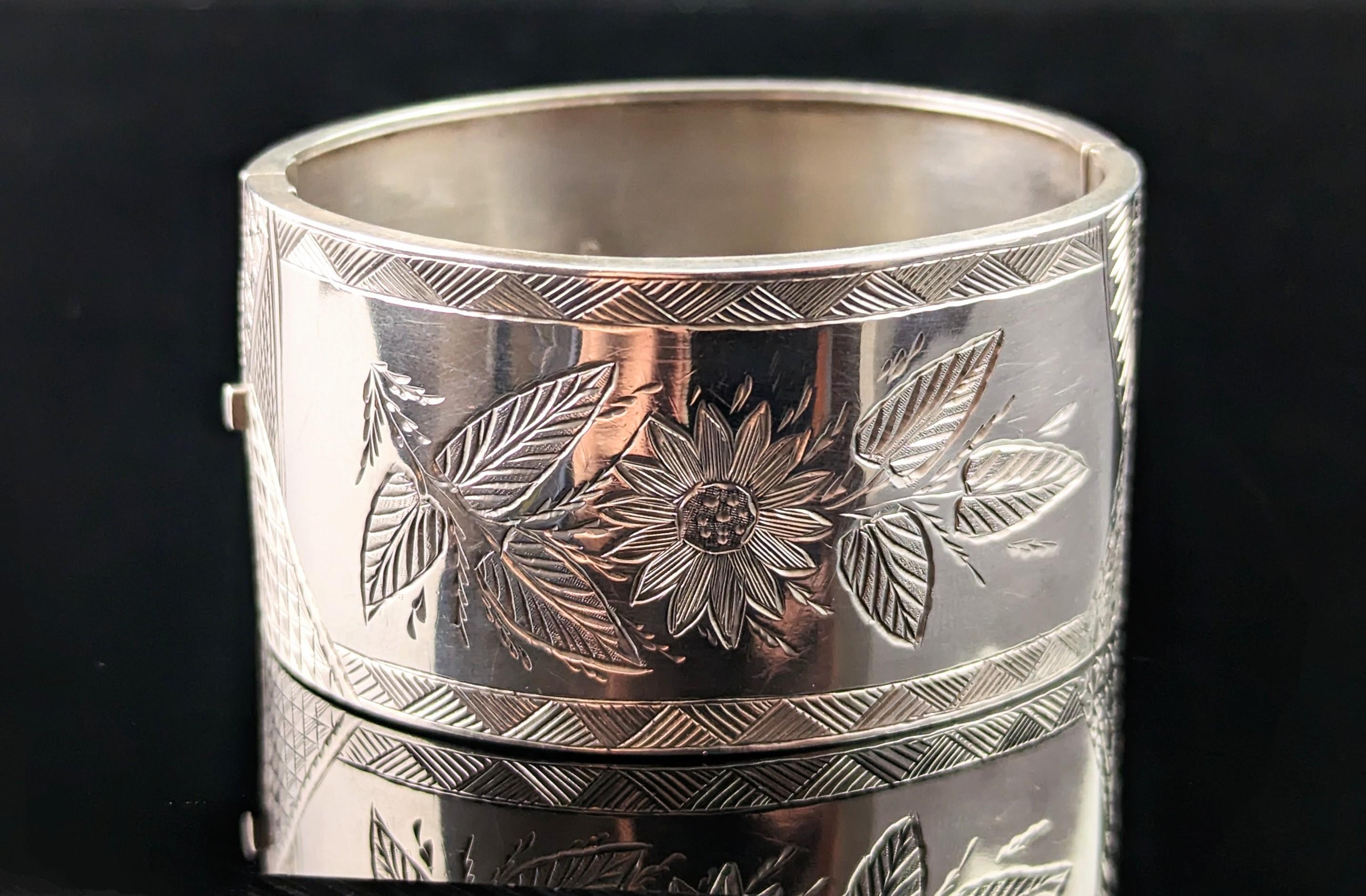 You can't help but fall in love with this gorgeous antique, Victorian era, sterling silver chunky cuff bangle.

Engraved in the aesthetic manner with a smooth polished reverse, it features a sunflower to the front.

A very well made and designed