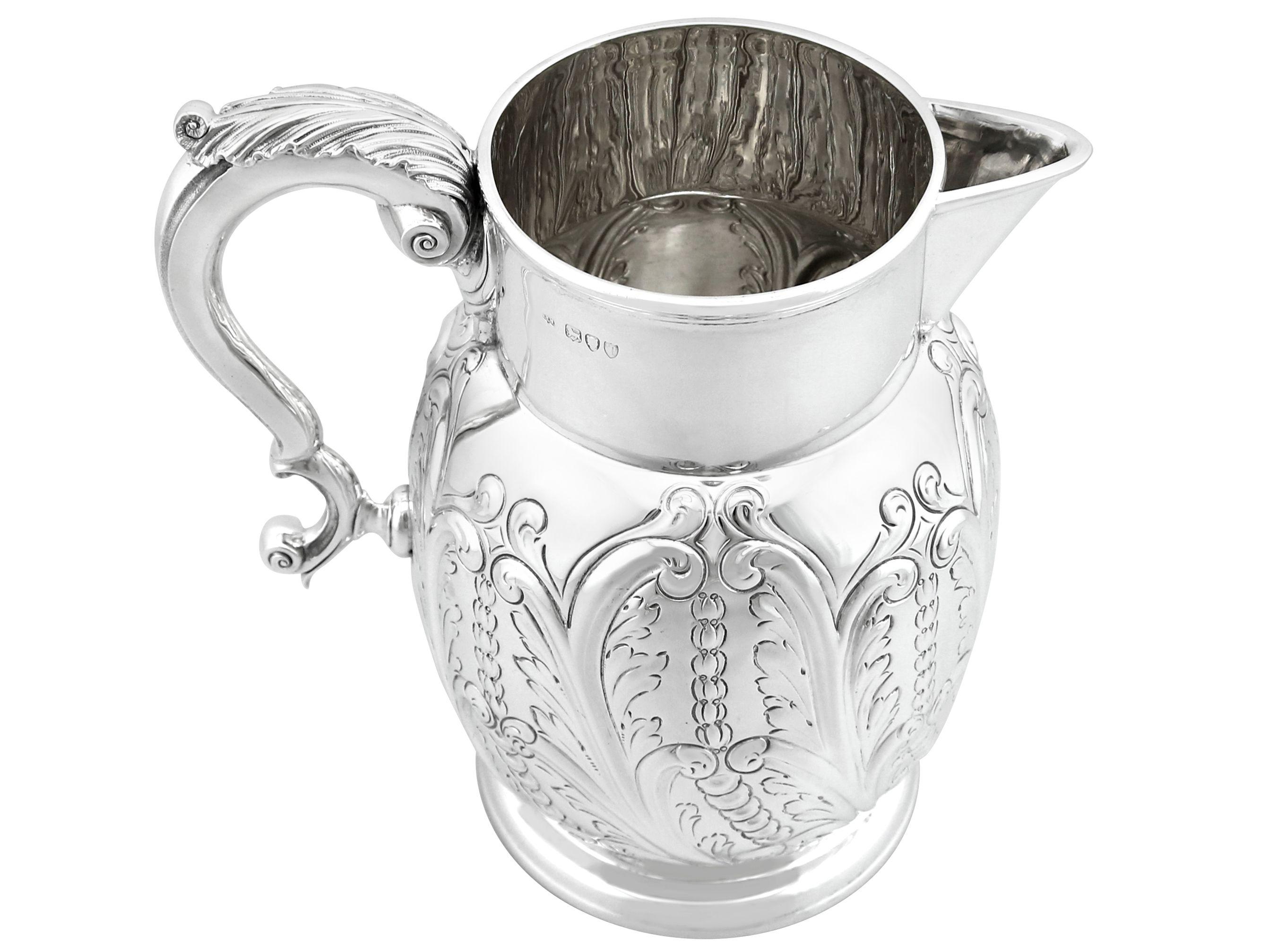 An exceptional, fine and impressive, large antique Victorian English sterling silver beer/water/cordial jug; part of our dining silverware collection

This exceptional antique English antique Victorian sterling silver water jug has a circular