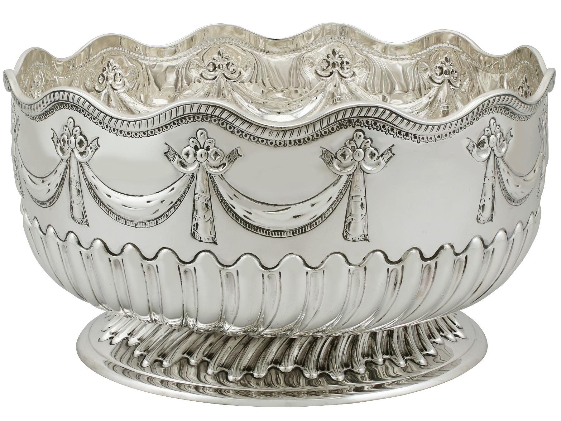 An exceptional, fine and impressive antique Victorian English sterling silver presentation bowl; an addition to our ornamental silverware collection.

This exceptional antique sterling silver bowl has a circular rounded form onto a circular