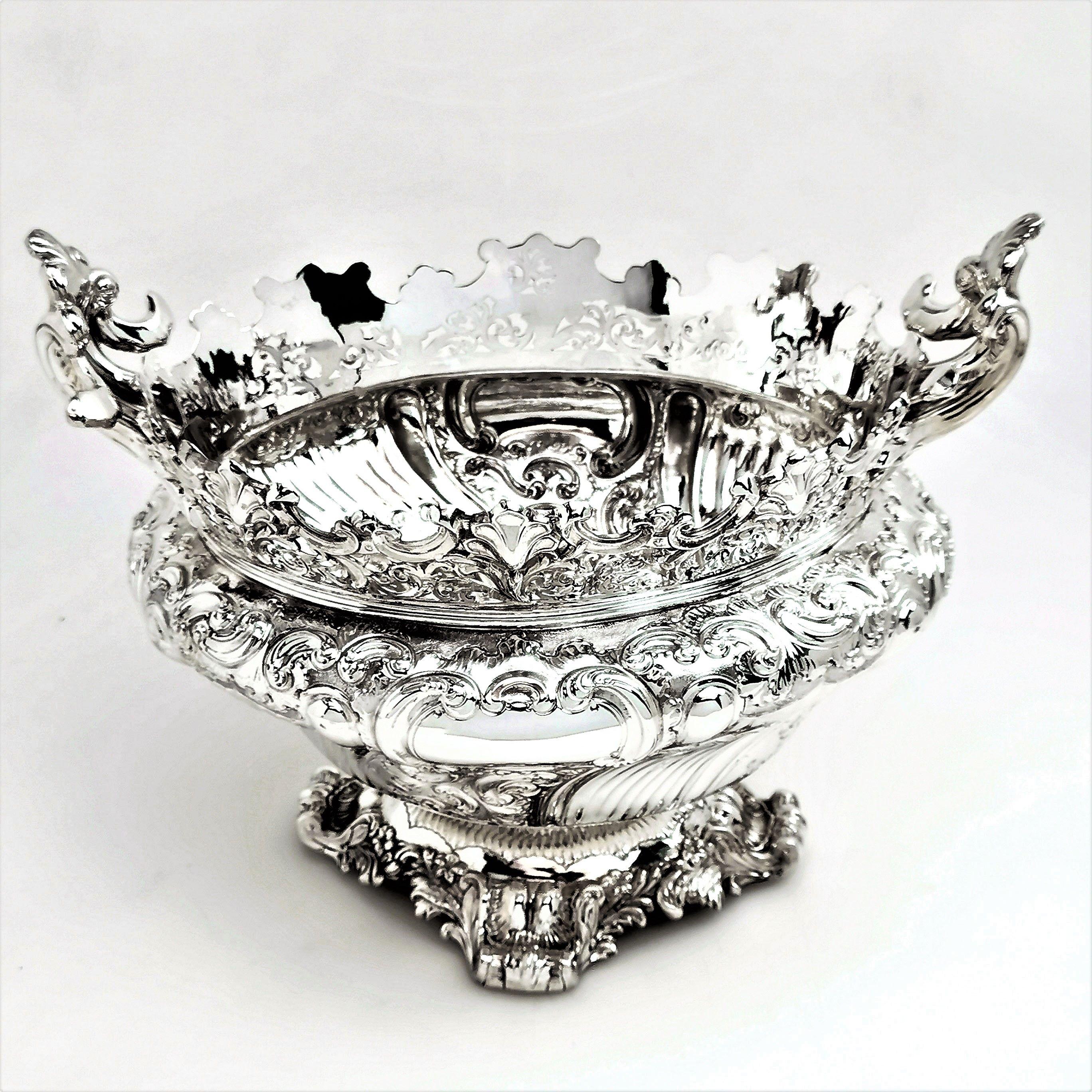 A magnificent antique Victorian solid silver bowl. This bowl is of notably impressive size and suitable for use as a centrepiece or fruit bowl. The dish is a shaped oval and is embellished with a rich chased design covering the body, rim and foot.