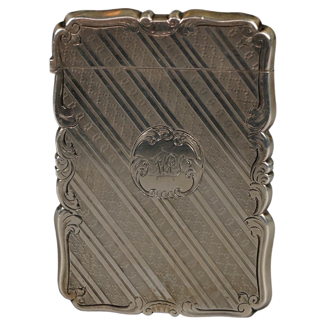 An antique Victorian calling card case offers sterling silver construction with foliate and scroll elements, monogrammed as photographed, c1890, 1.53 toz

Measures- 3.5''H x .25''W x 2.5''D.
