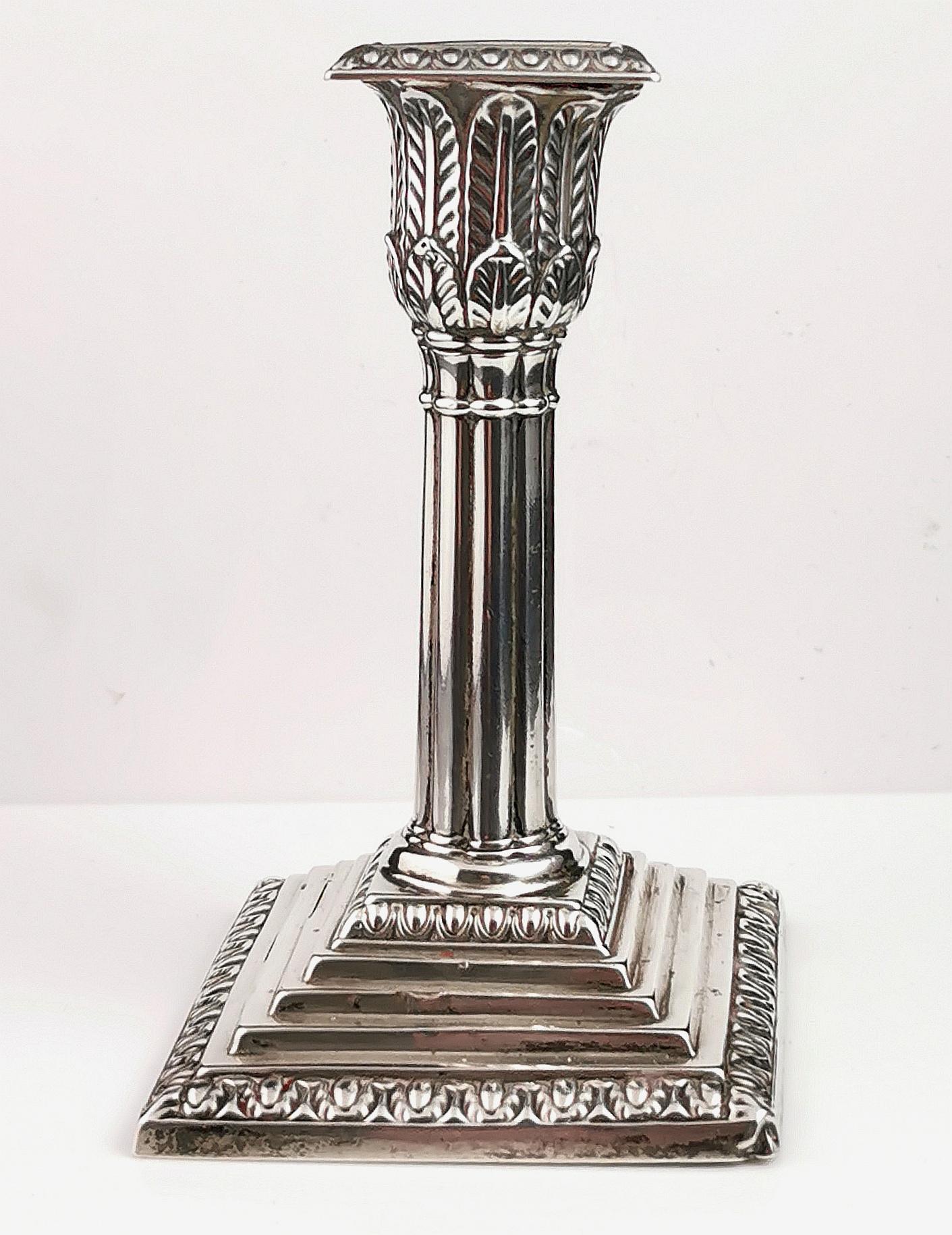 A beautiful and grand antique Victorian sterling silver candlestick.

It is a single candlestick, made from sterling silver with a weighted base and a corinthian column style stem.

Top and base are both squared and decorated with acanthus