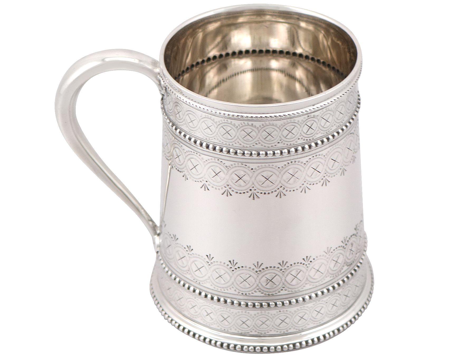 An exceptional, fine and impressive antique Victorian English sterling silver christening mug; an addition to our silver christening collection.

This exceptional antique Victorian sterling silver christening mug has a tapering cylindrical