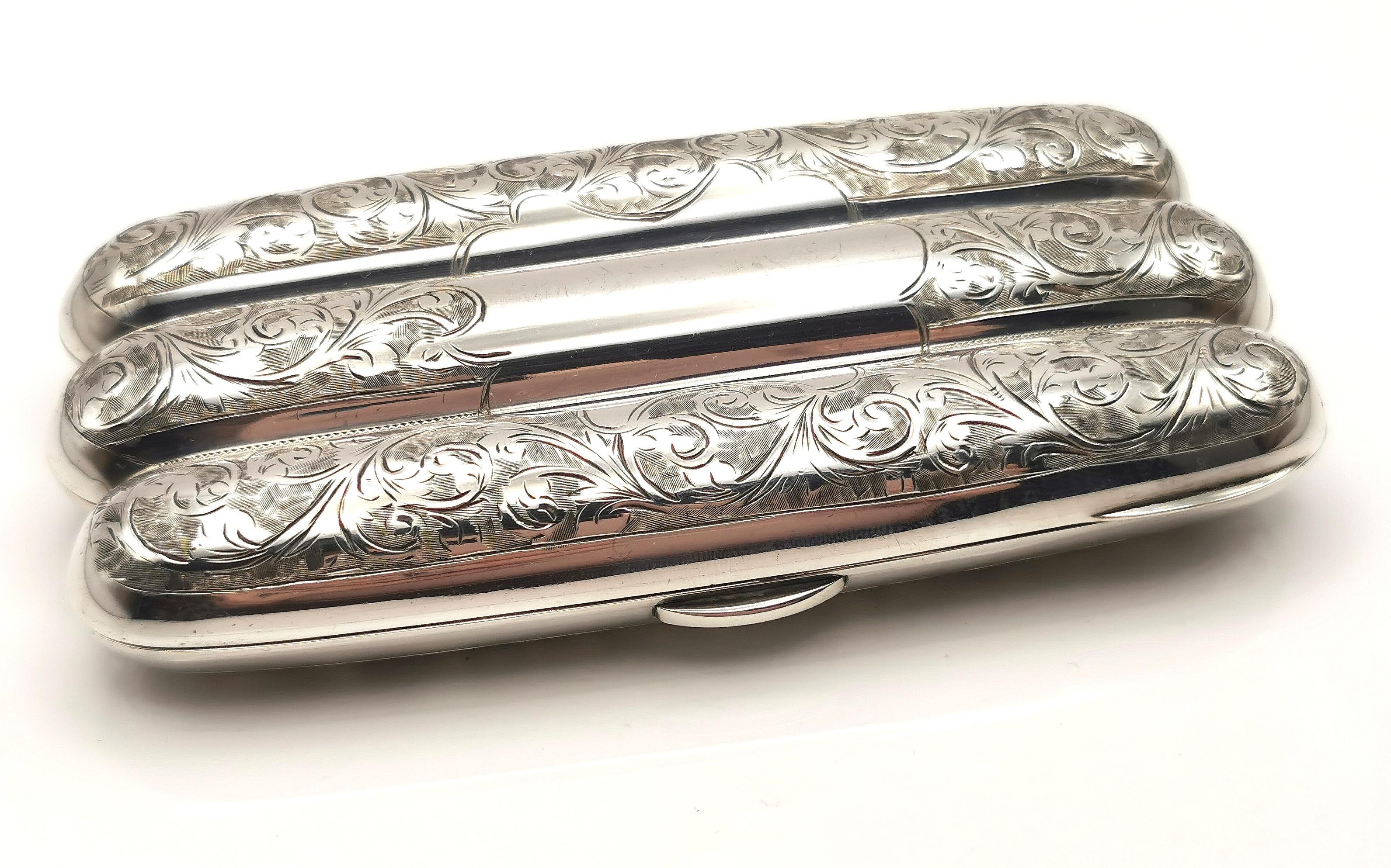 An attractive and decorative antique sterling silver cigar case.

A lovely substantial and heavy piece, made from heavily engraved sterling silver, the case is gilt lined and still retains most of its rich gilt finish.

The engraving has a foliate