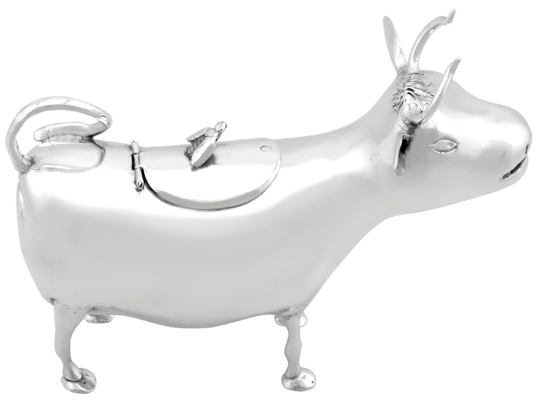 An exceptional, fine and impressive antique Victorian English sterling silver cow creamer; an addition to our 19th Century silverware collection.

This exceptional antique Victorian sterling silver creamer has been realistically modelled in the form