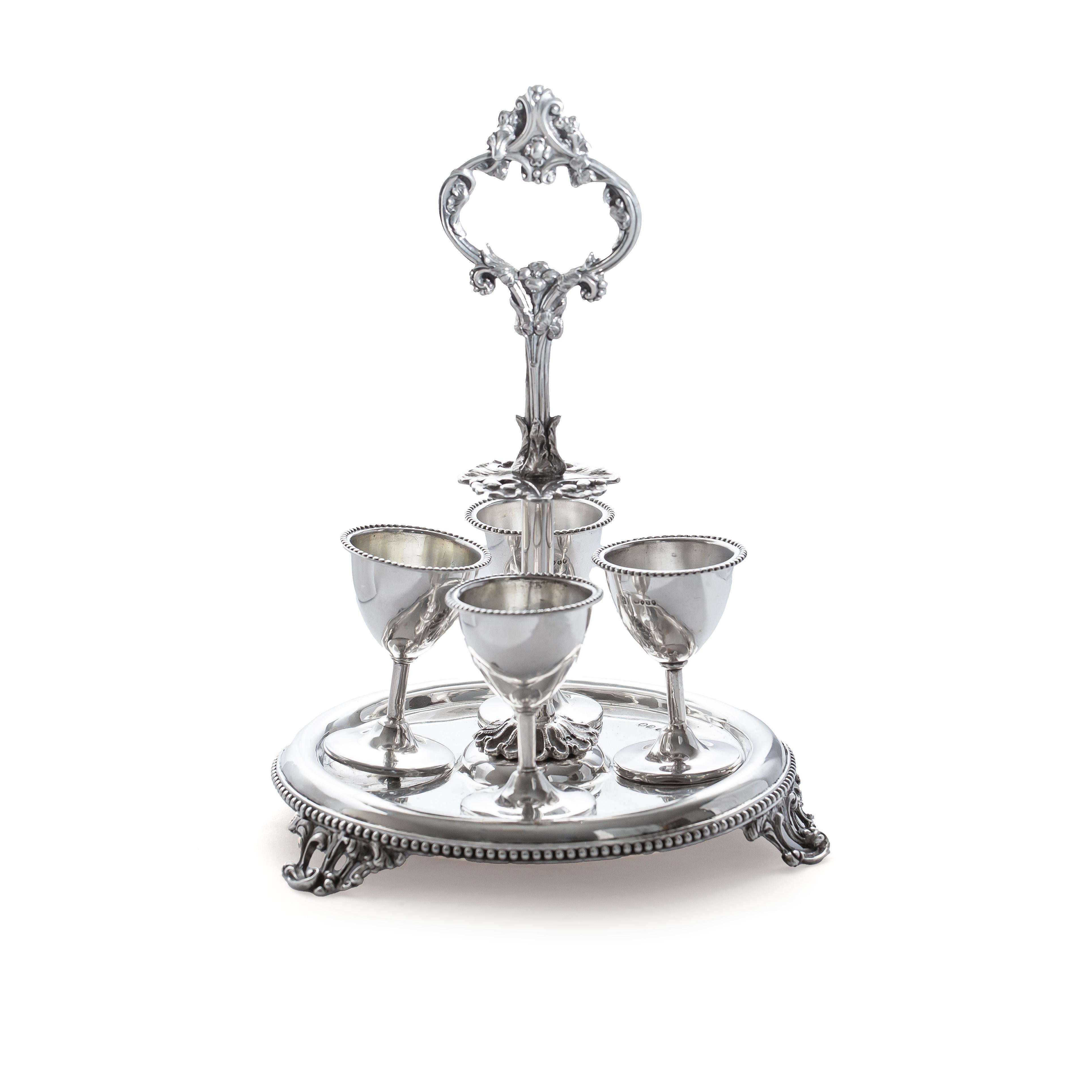 Antique Victorian sterling 925 silver cruet set of 4 with a holder. 
Made in England, 1857
Maker:H J Lias & Son (Henry John Lias & Henry John Lias)
Fully hallmarked.

Dimensions:
Diameter x Height: 17.5 x 25 cm 
Cup size: Diameter x Height: 7.2 cm