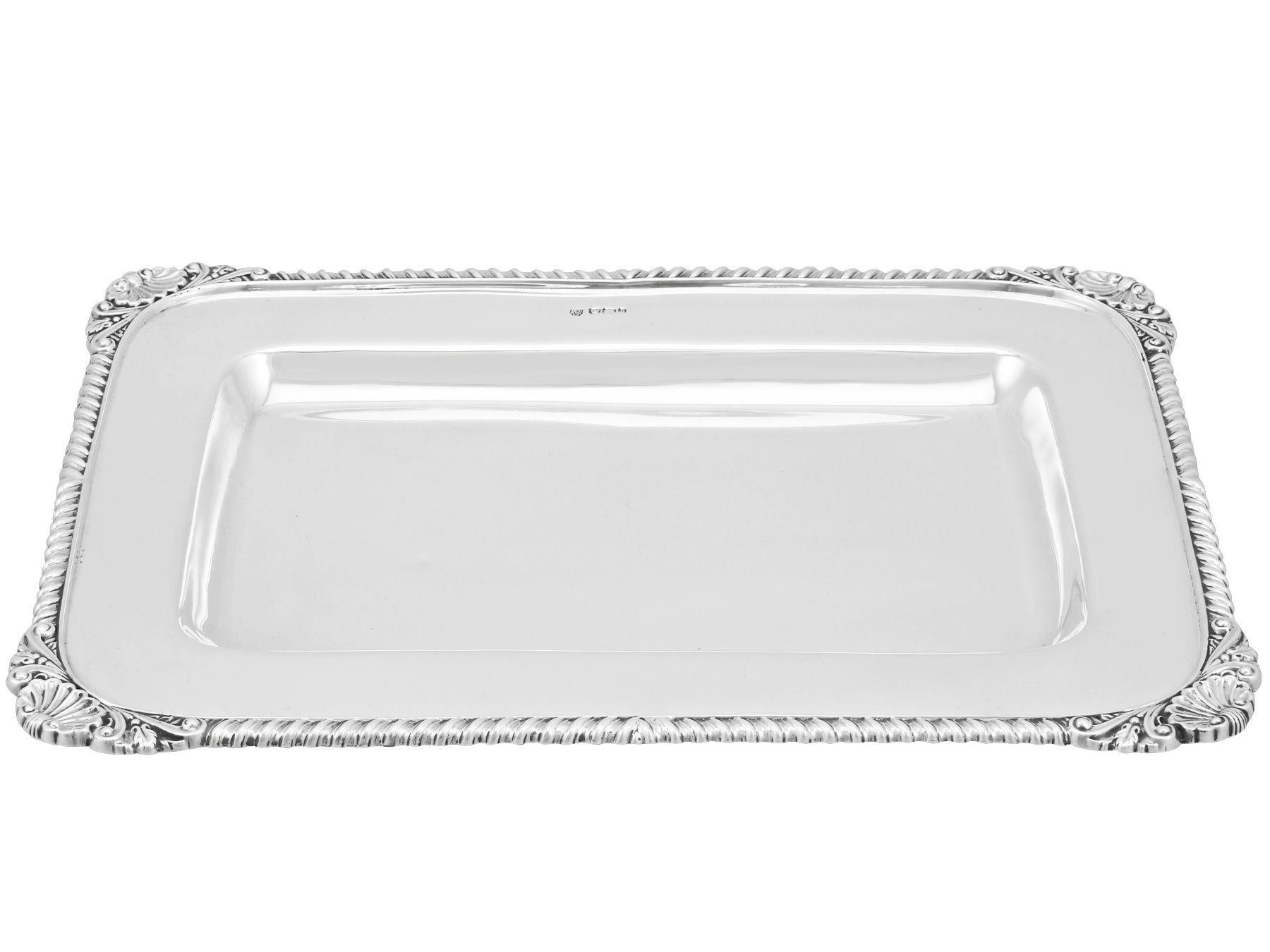 An exceptional, fine and impressive antique Victorian English sterling silver drinks tray; an addition to our silver tray collection

This exceptional Victorian sterling silver tray has a rectangular form with rounded corners.

The surface of