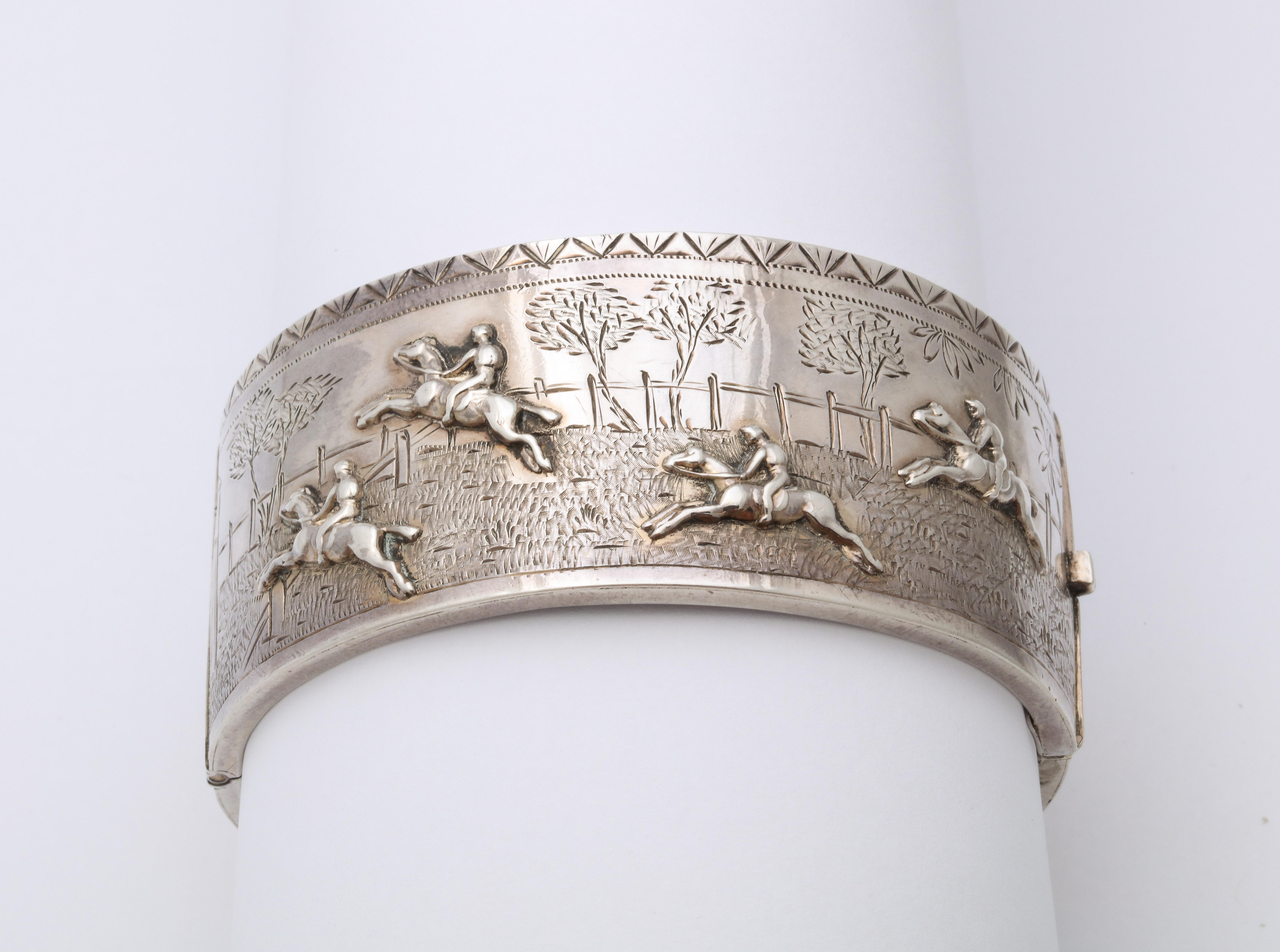 This is a scarce indeed, a sterling Victorian bracelet with a repousse landscape scene of trees, barn, running fences and horses jumping with their riders racing to a hunt. The raised engraving is so exciting that you can feel the speed of the
