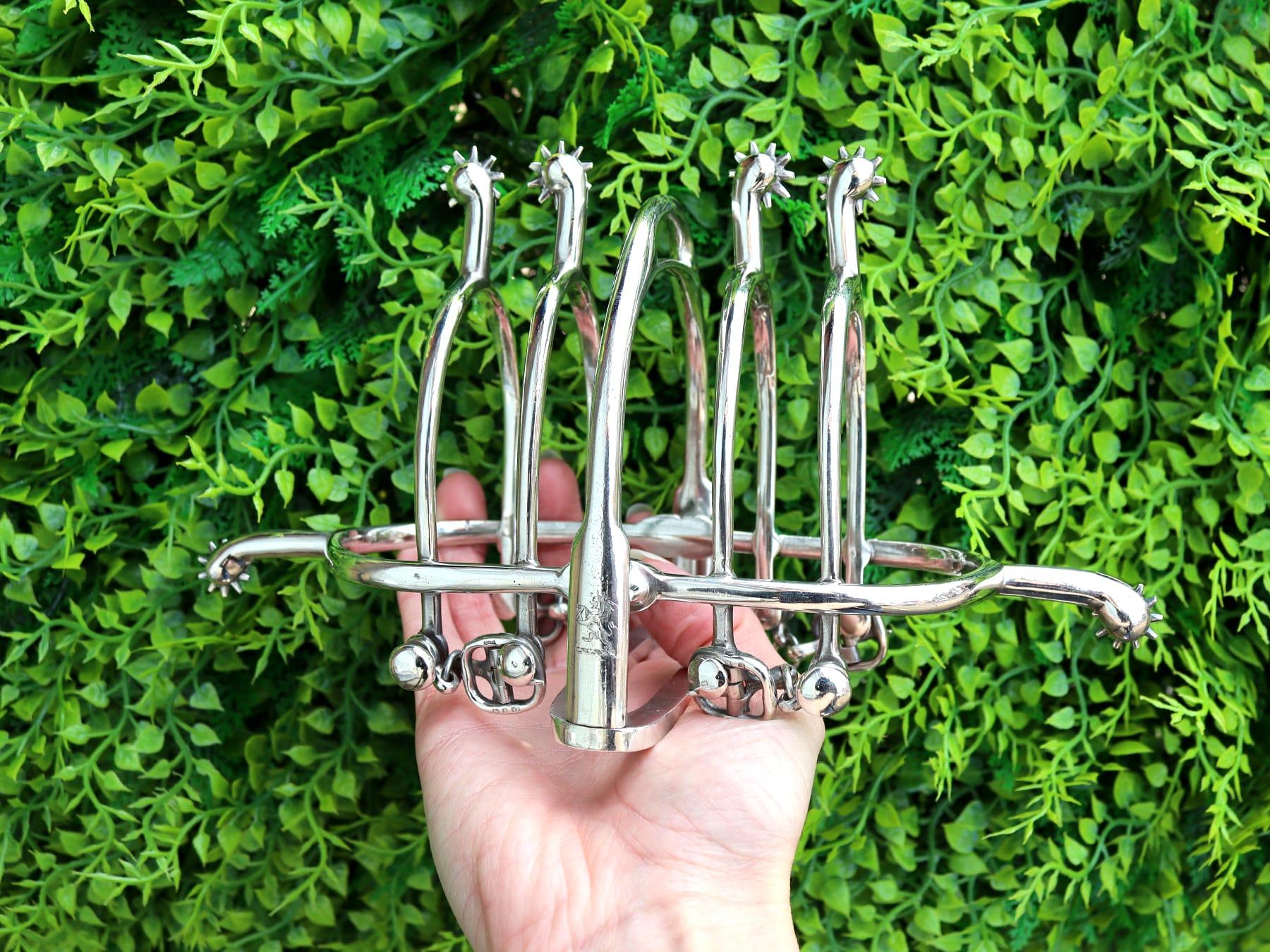 An exceptional, fine and impressive, rare antique Victorian English sterling silver toast rack with equestrian influence; an addition to our dining silverware collection.

This exceptional and rare antique silver toast rack has an oval-shaped