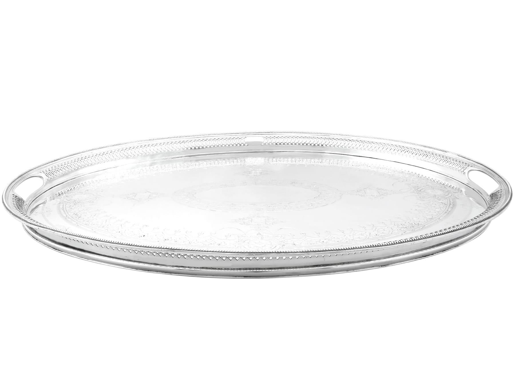 An exceptional, fine and impressive antique Victorian English sterling silver gallery tea tray; an addition to our diverse collection of serving trays.

This exceptional antique Victorian sterling silver gallery tray has an oval form.

The surface