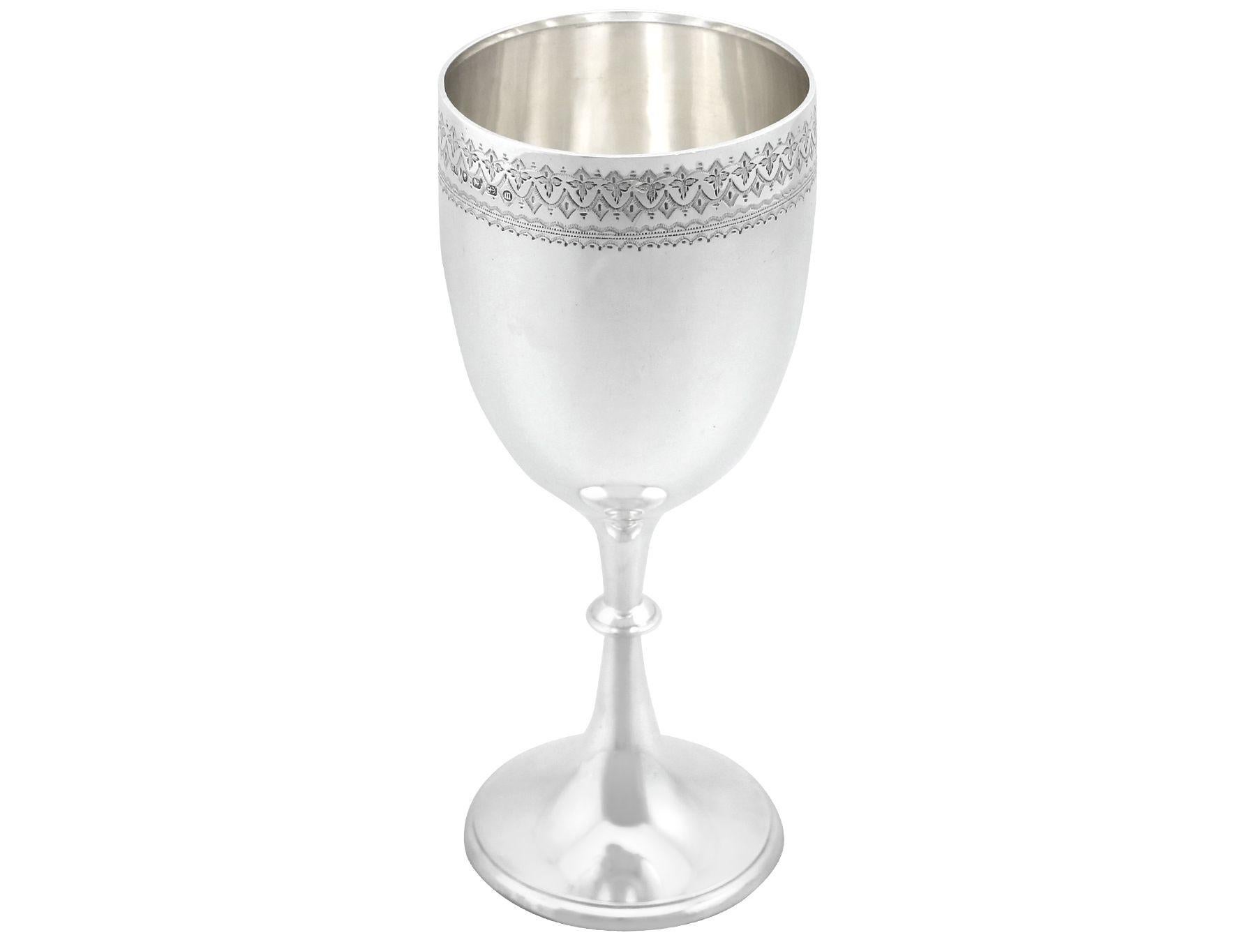 An exceptional, fine and impressive antique Victorian English sterling silver goblet; an addition to our collection of presentation related silverware.

This exceptional antique Victorian sterling silver goblet has a circular bell shaped form onto