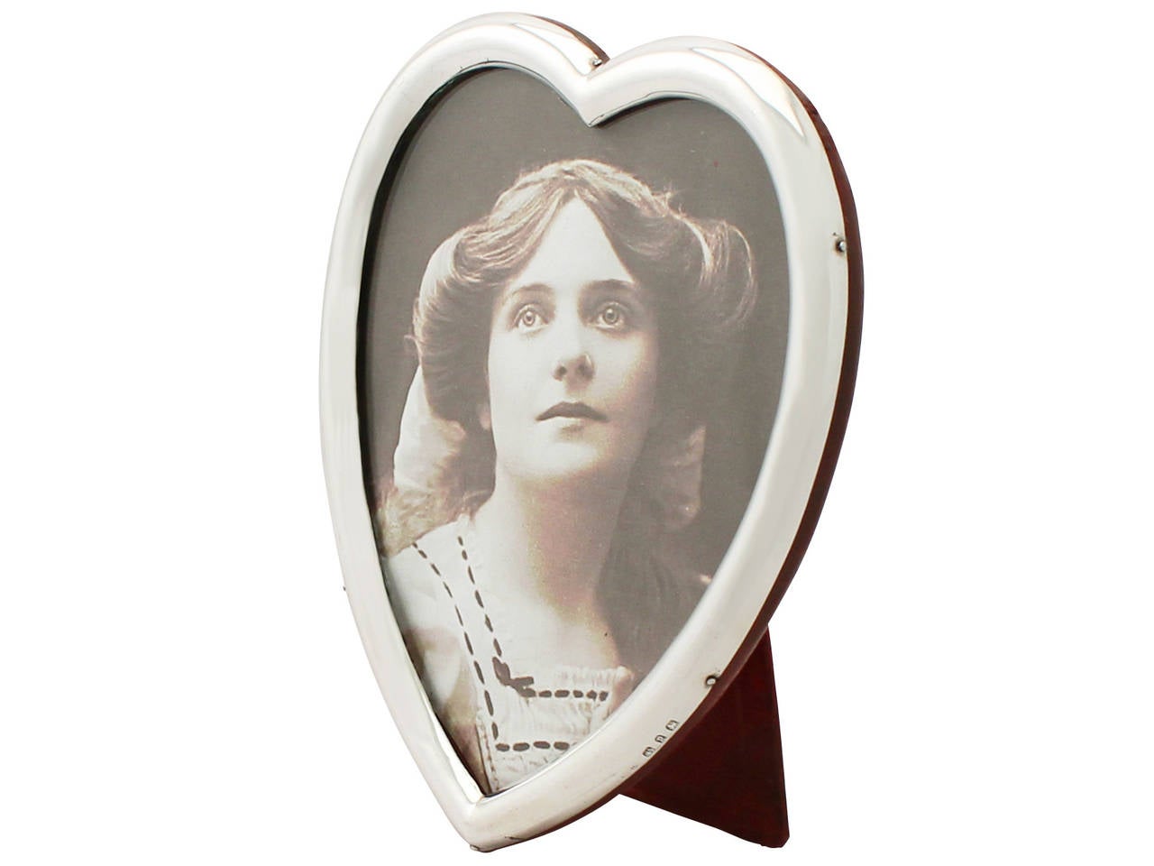 A fine and impressive antique Victorian English sterling silver heart shaped photograph frame; an addition to our ornamental silverware collection.

This fine antique Victorian sterling silver photo frame has a plain rounded heart shaped