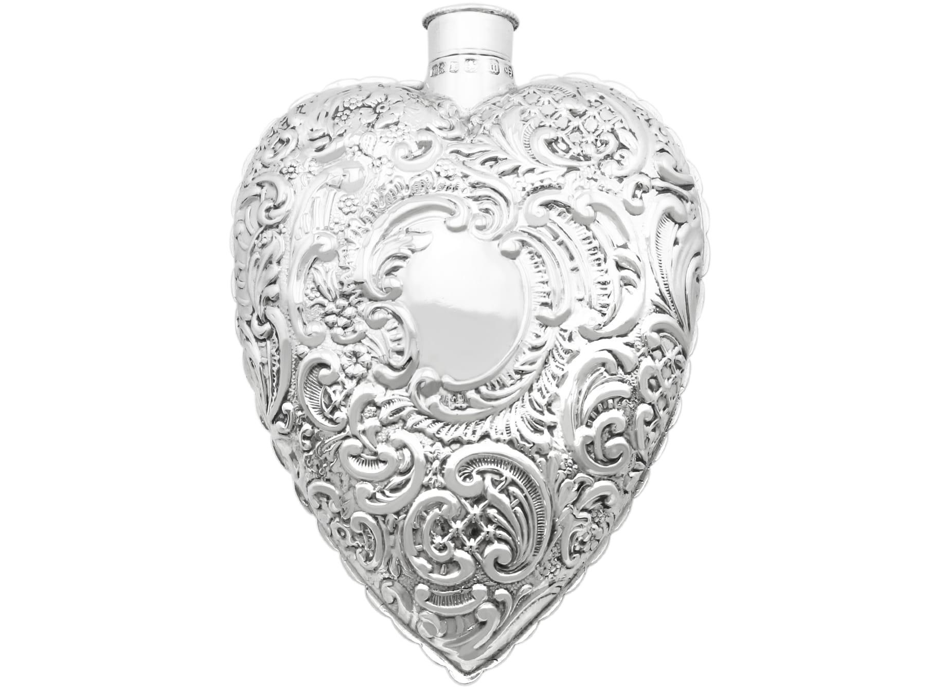 An exceptional, fine and impressive antique Victorian English sterling silver heart-shaped scent flask; an addition to our diverse silverware collection.

This fine antique Victorian sterling silver scent flask has a heart-shaped form.

Each surface