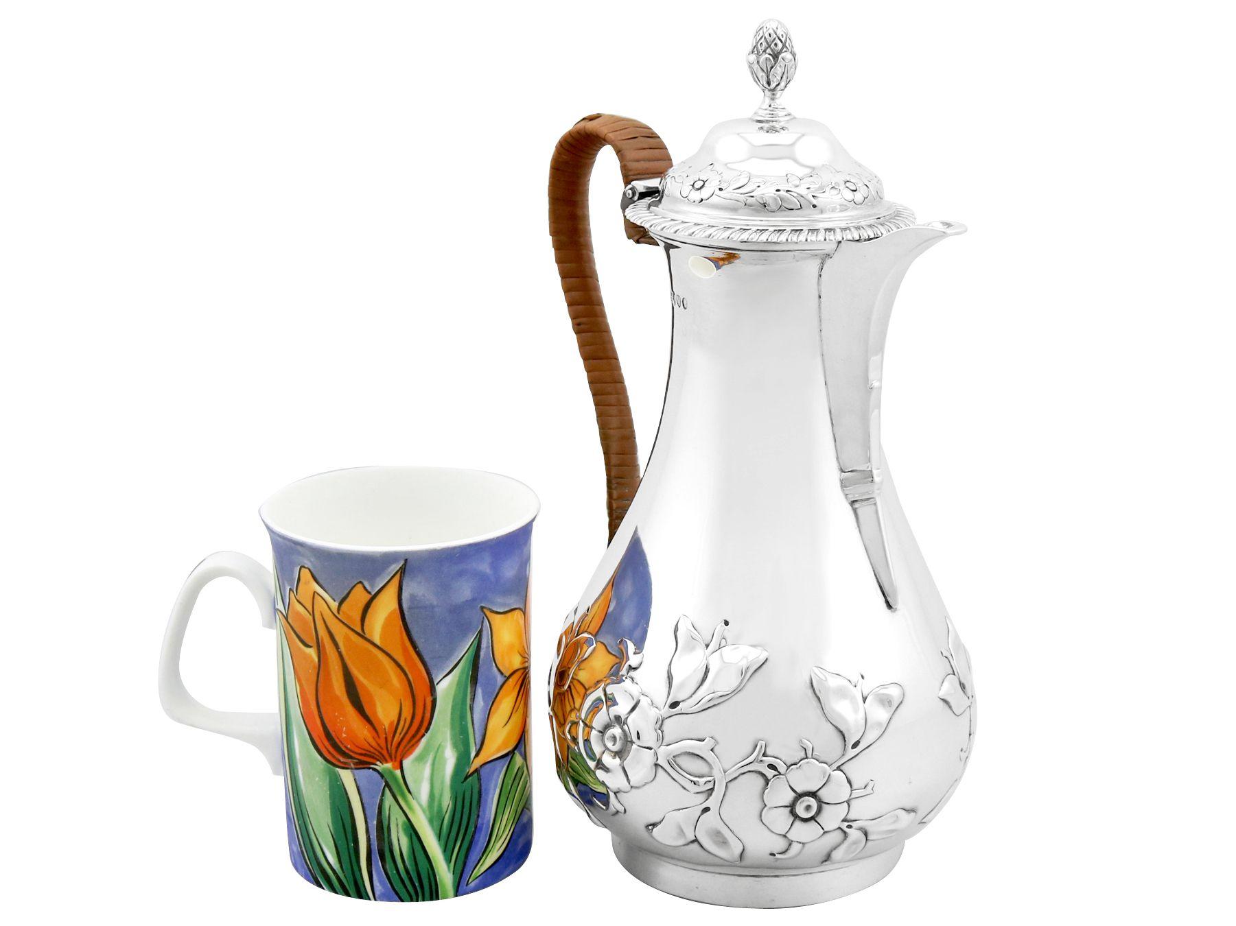 A fine and impressive antique Victorian English sterling silver hot water / coffee jug; an addition to our diverse silver teaware collection.

This fine antique Victorian sterling silver jug has a pear shaped form onto a circular collet