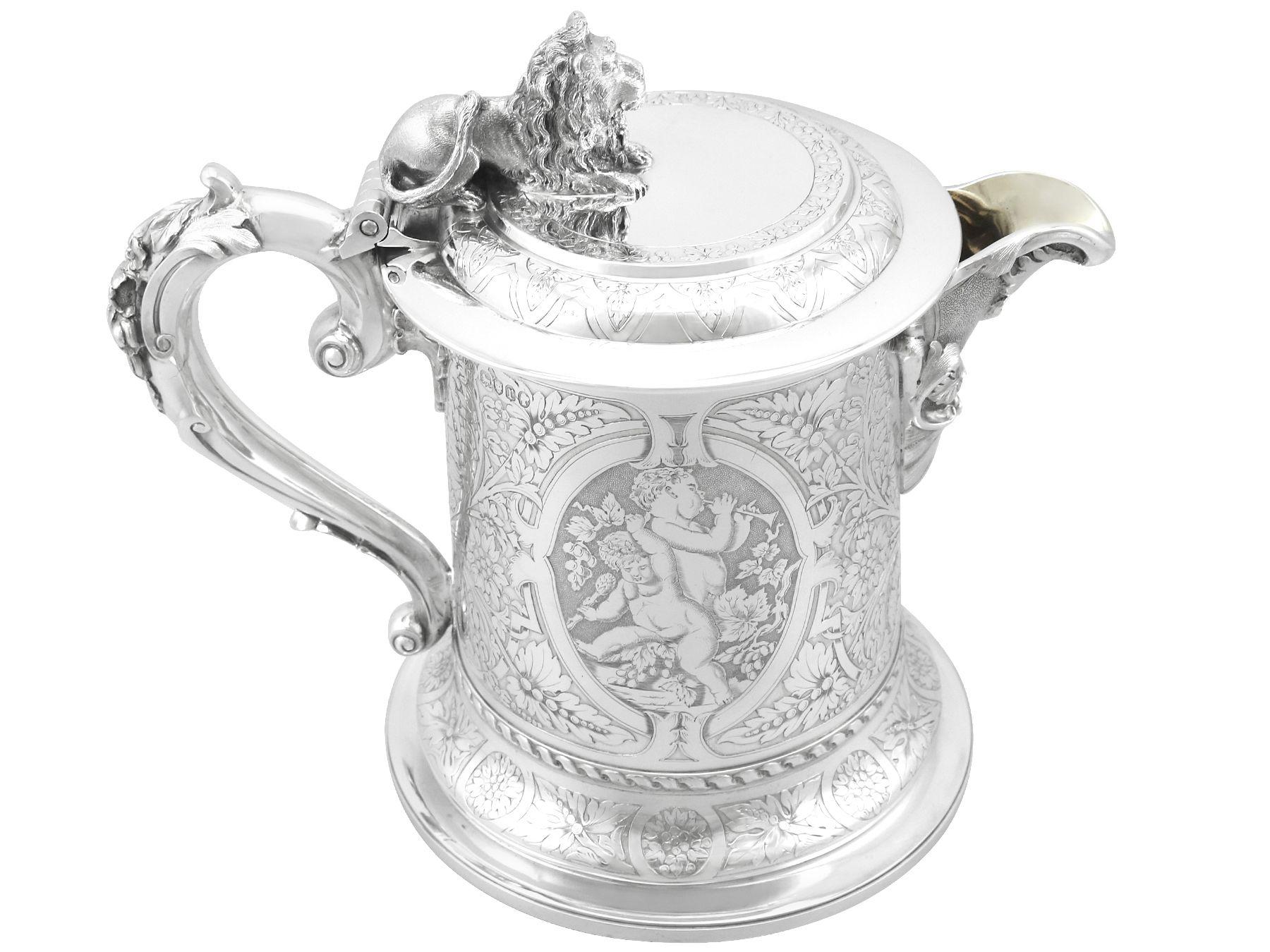 A magnificent, fine and impressive antique Victorian English sterling silver lidded jug; part of our wine and drinks related silverware collection.

This magnificent antique Victorian English sterling silver jug has a plain tapering cylindrical form