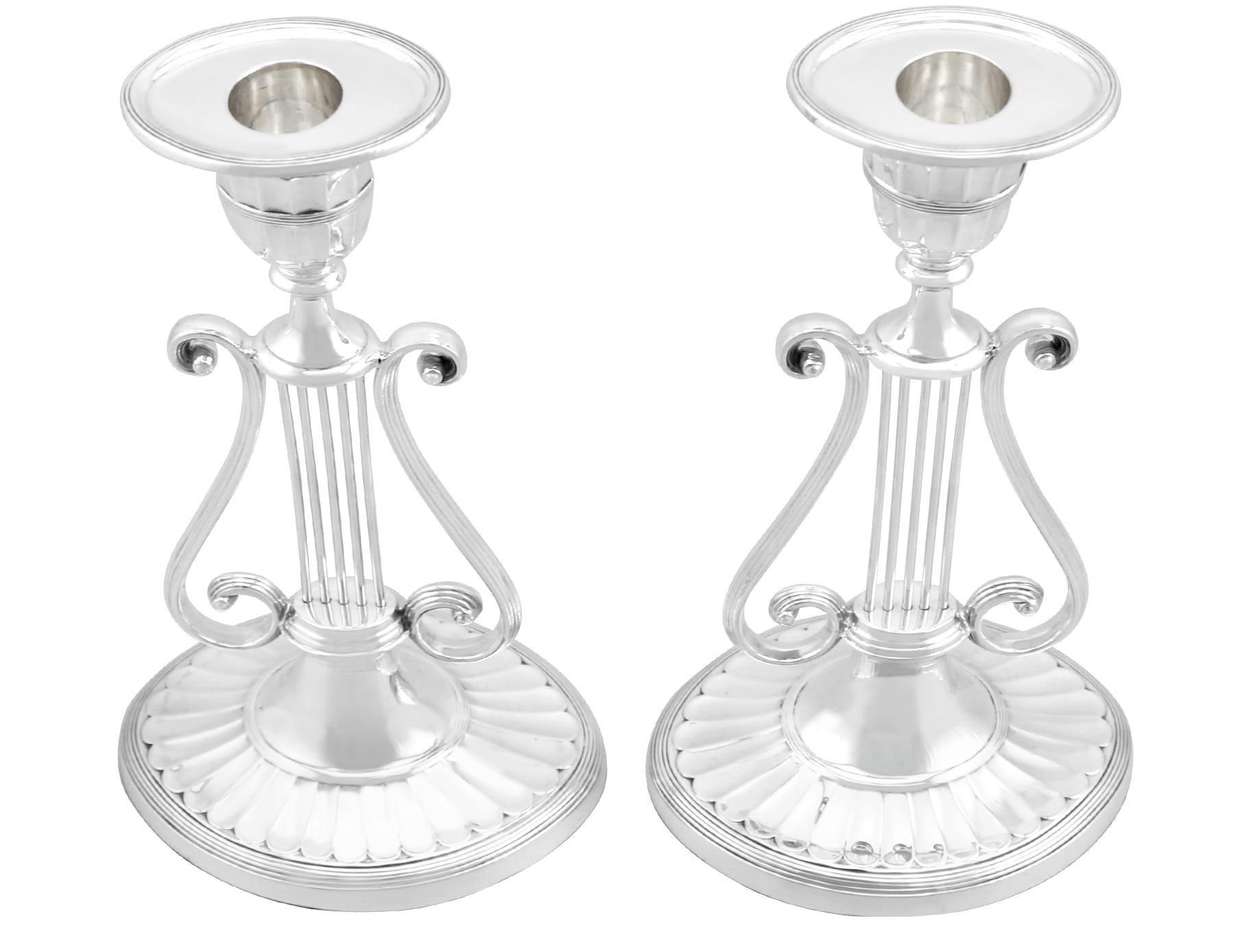 An exceptional, fine and impressive pair of antique Victorian English sterling silver lyre candlesticks; an addition of our ornamental silverware collection

These exceptional antique Victorian English sterling silver candlesticks have been