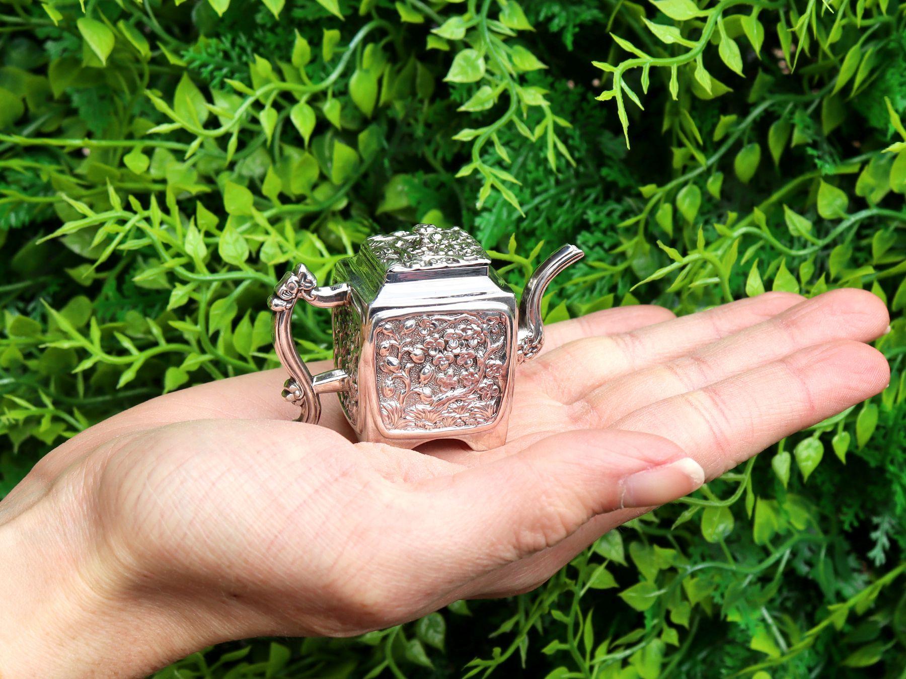 An exceptional, fine and impressive, miniature antique Victorian English sterling silver teapot in the Chinoiserie style; an addition to our silver teaware collection

This exceptional and rare antique Victorian sterling silver miniature teapot has