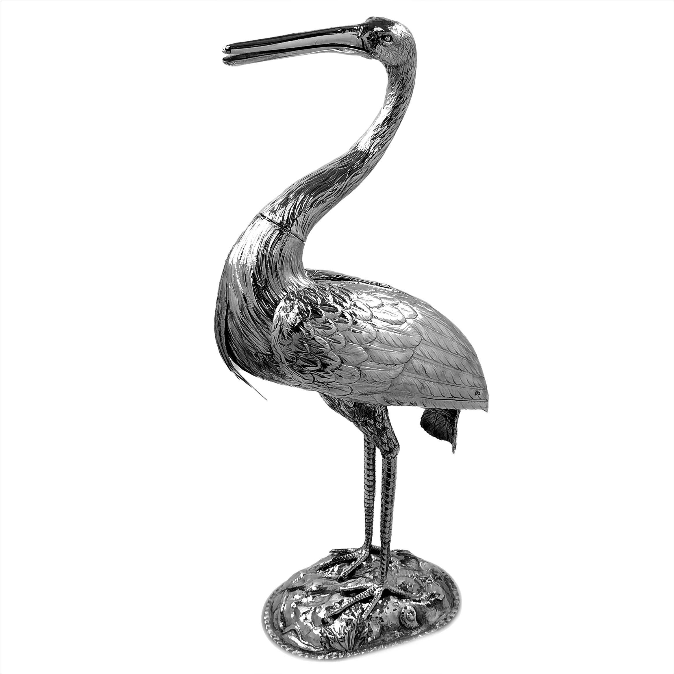 A large, magnificent Victorian era solid Silver model of a Crane / Heron. This tall figure of a Bird stands on a square base embellished with snakes and shells. The Crane / Heron is created with a lovely attention to detail and is a statement piece.